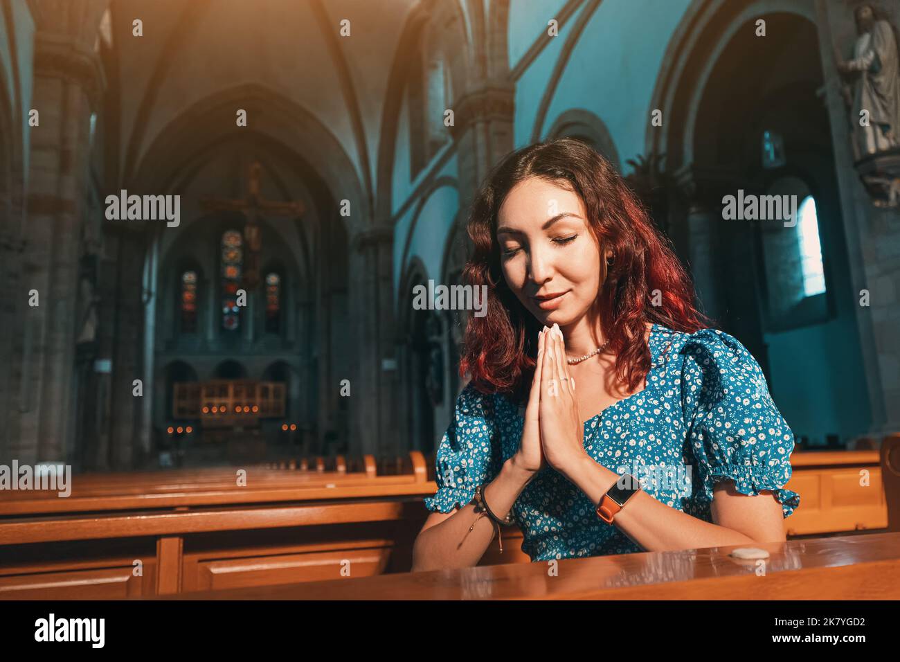 The girl prays in the Catholic Church and asks God for health ...