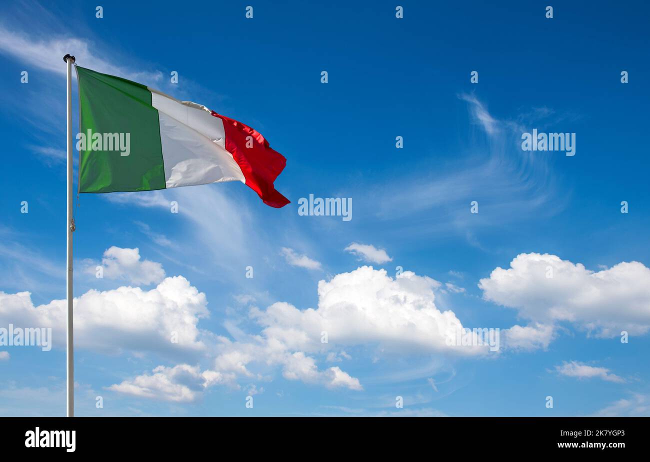 Italian flag on blue sky background Stock Photo