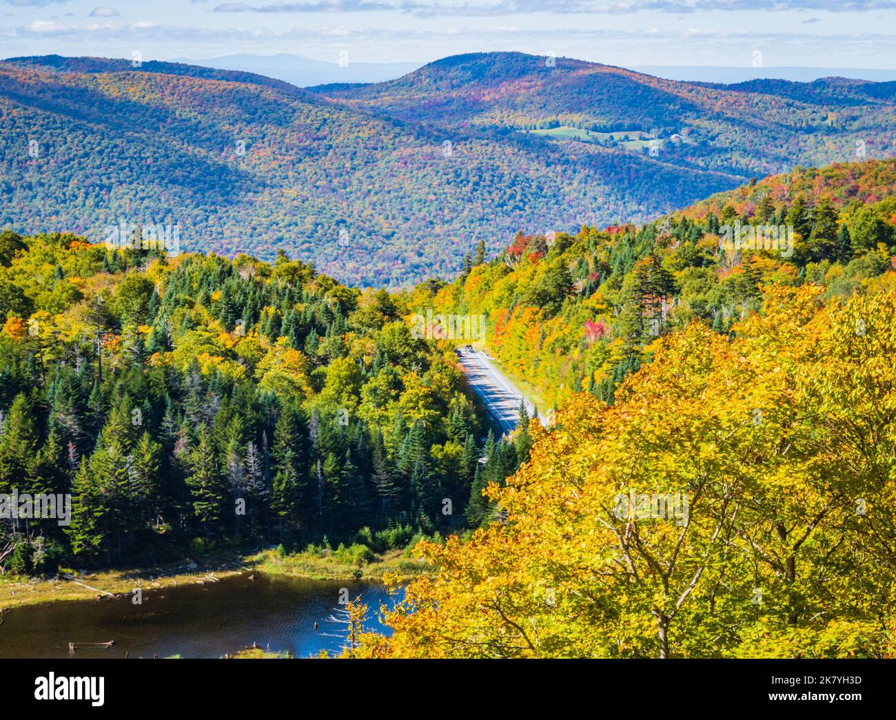 road winds through the Appalachian Gap, a mountain pass in the Green Mountains of Vermont, in bright colored fall foliage Stock Photo