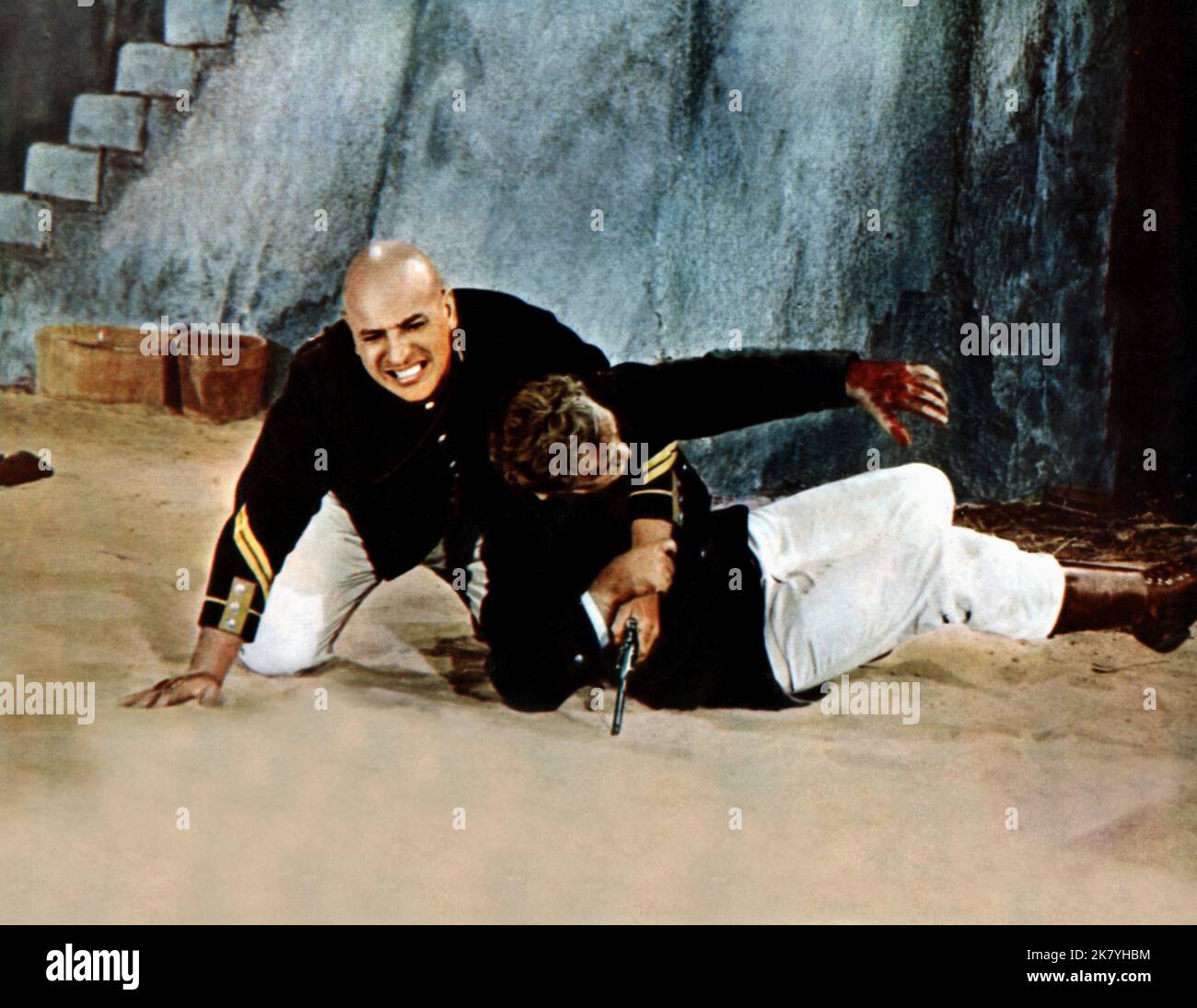Telly Savalas Film: Beau Geste (USA 1966) Characters: Sergeant Major Dagineau  Director: Douglas Heyes 02 September 1966   **WARNING** This Photograph is for editorial use only and is the copyright of UNIVERSAL and/or the Photographer assigned by the Film or Production Company and can only be reproduced by publications in conjunction with the promotion of the above Film. A Mandatory Credit To UNIVERSAL is required. The Photographer should also be credited when known. No commercial use can be granted without written authority from the Film Company. Stock Photo