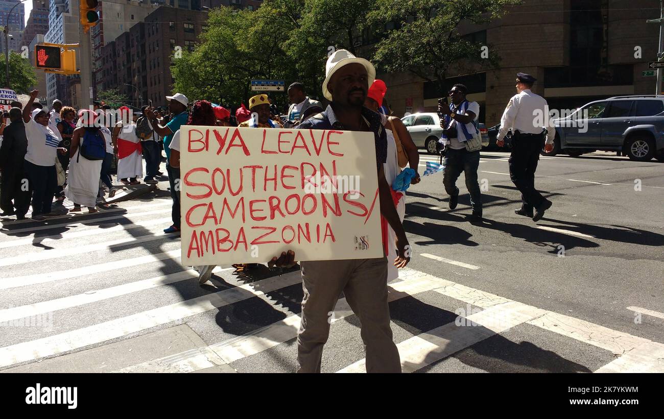 New York City, New York, USA - Sept 22 2017: Near the United Nations, a protester holds a sign that says, 'Biya Leave Southern Cameroons/Ambazonia'. Stock Photo