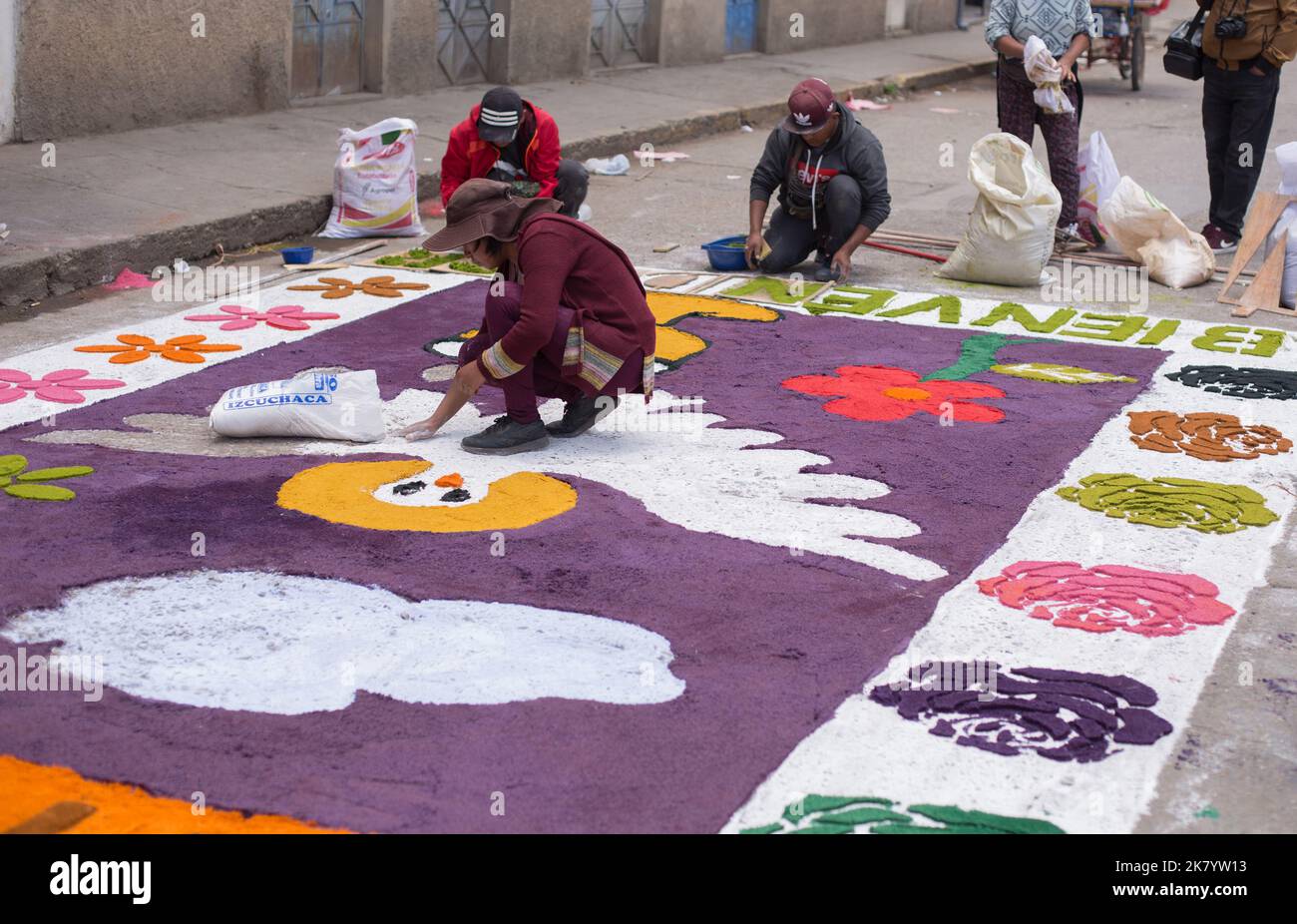 People assembling carpets for the procession of the 'Señor de los Milagros'. Concept of religious traditions in Peru. Stock Photo
