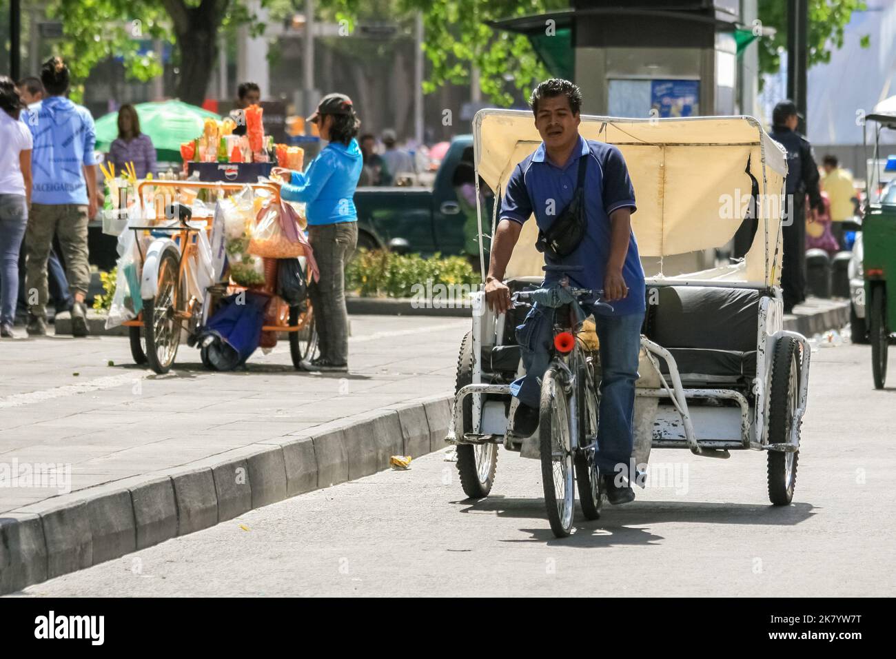 Mexico City, Mexico - 04 25 2010: A vehicle carrying people and its driver in Mexico City. Bicycle taxi Stock Photo