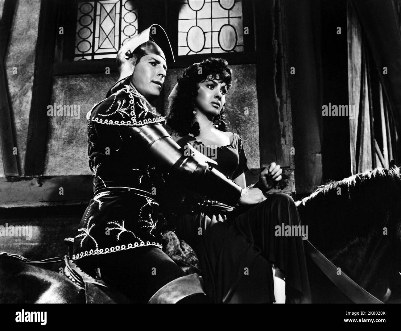 Jean Danet & Gina Lollobrigida Film: Notre Dame De Paris; The Hunchback Of Notre Dame (1956) Characters: Phoebus de Chateaupers, Esmeralda  Director: Jean Delannoy 19 December 1956   **WARNING** This Photograph is for editorial use only and is the copyright of ALLIED ARTISTS and/or the Photographer assigned by the Film or Production Company and can only be reproduced by publications in conjunction with the promotion of the above Film. A Mandatory Credit To ALLIED ARTISTS is required. The Photographer should also be credited when known. No commercial use can be granted without written authority Stock Photo