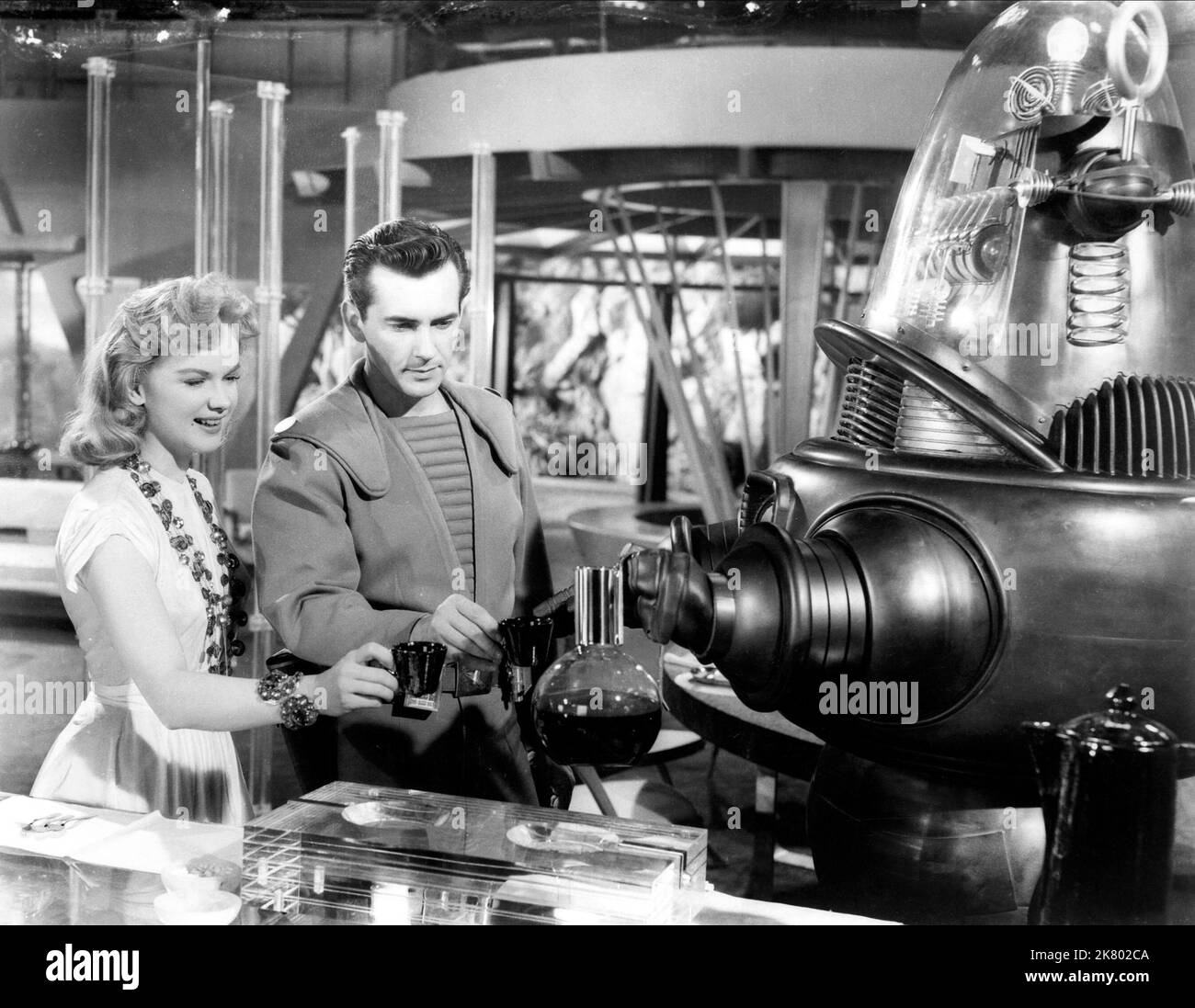 Anne Francis, Warren Stevens & Robby The Robot Film: Forbidden Planet (USA 1956) Characters: Altaira 'Alta' Morbius, Lt. 'Doc' Ostrow M.D., Himself  Director: Fred M.Wilcox 23 March 1956   **WARNING** This Photograph is for editorial use only and is the copyright of MGM and/or the Photographer assigned by the Film or Production Company and can only be reproduced by publications in conjunction with the promotion of the above Film. A Mandatory Credit To MGM is required. The Photographer should also be credited when known. No commercial use can be granted without written authority from the Film C Stock Photo