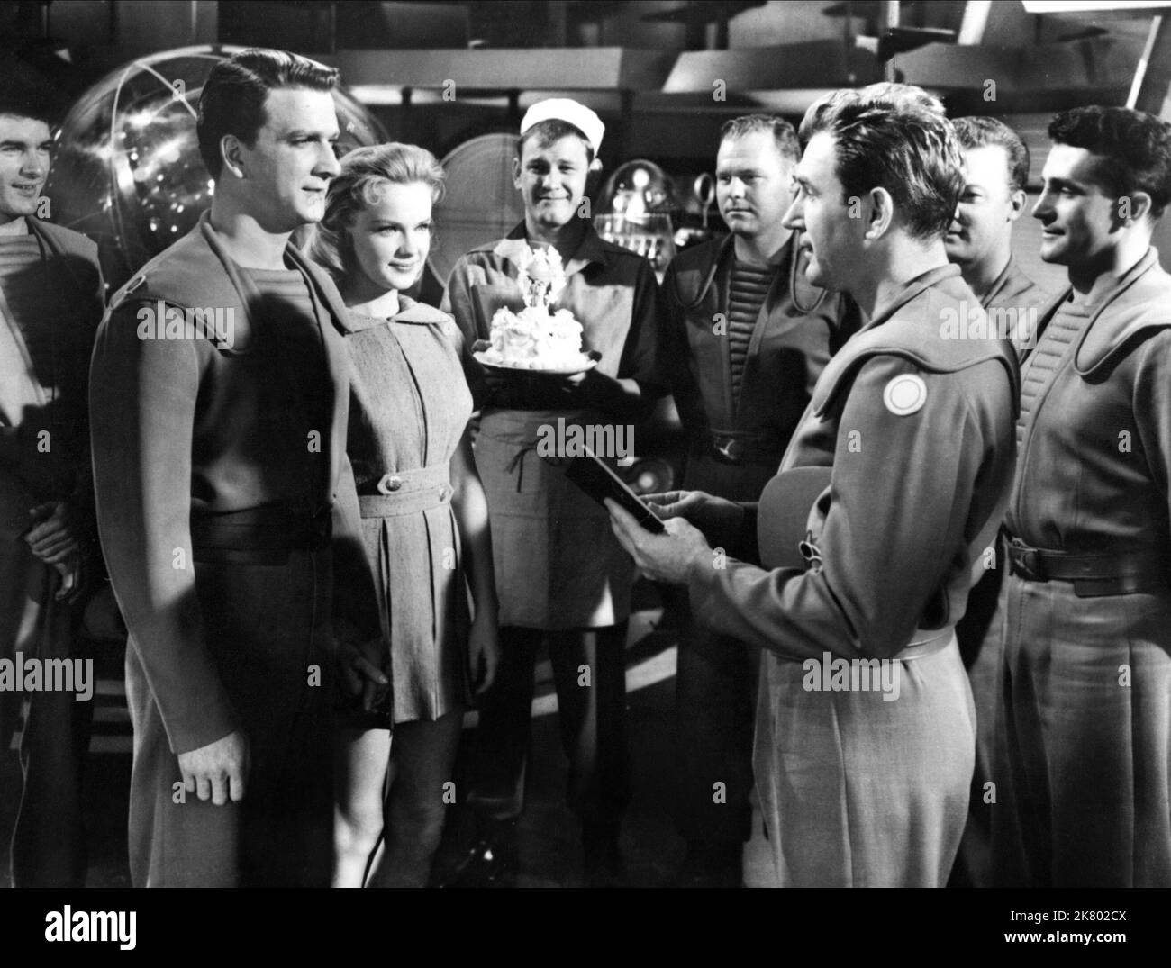 Leslie Nielsen, Anne Francis, Earl Holliman & Walter Pidgeon Film: Forbidden Planet (USA 1956) Characters: Commander J. J. Adams, Altaira 'Alta' Morbius, Cook, Dr. Edward Morbius  Director: Fred M.Wilcox 23 March 1956   **WARNING** This Photograph is for editorial use only and is the copyright of MGM and/or the Photographer assigned by the Film or Production Company and can only be reproduced by publications in conjunction with the promotion of the above Film. A Mandatory Credit To MGM is required. The Photographer should also be credited when known. No commercial use can be granted without wr Stock Photo