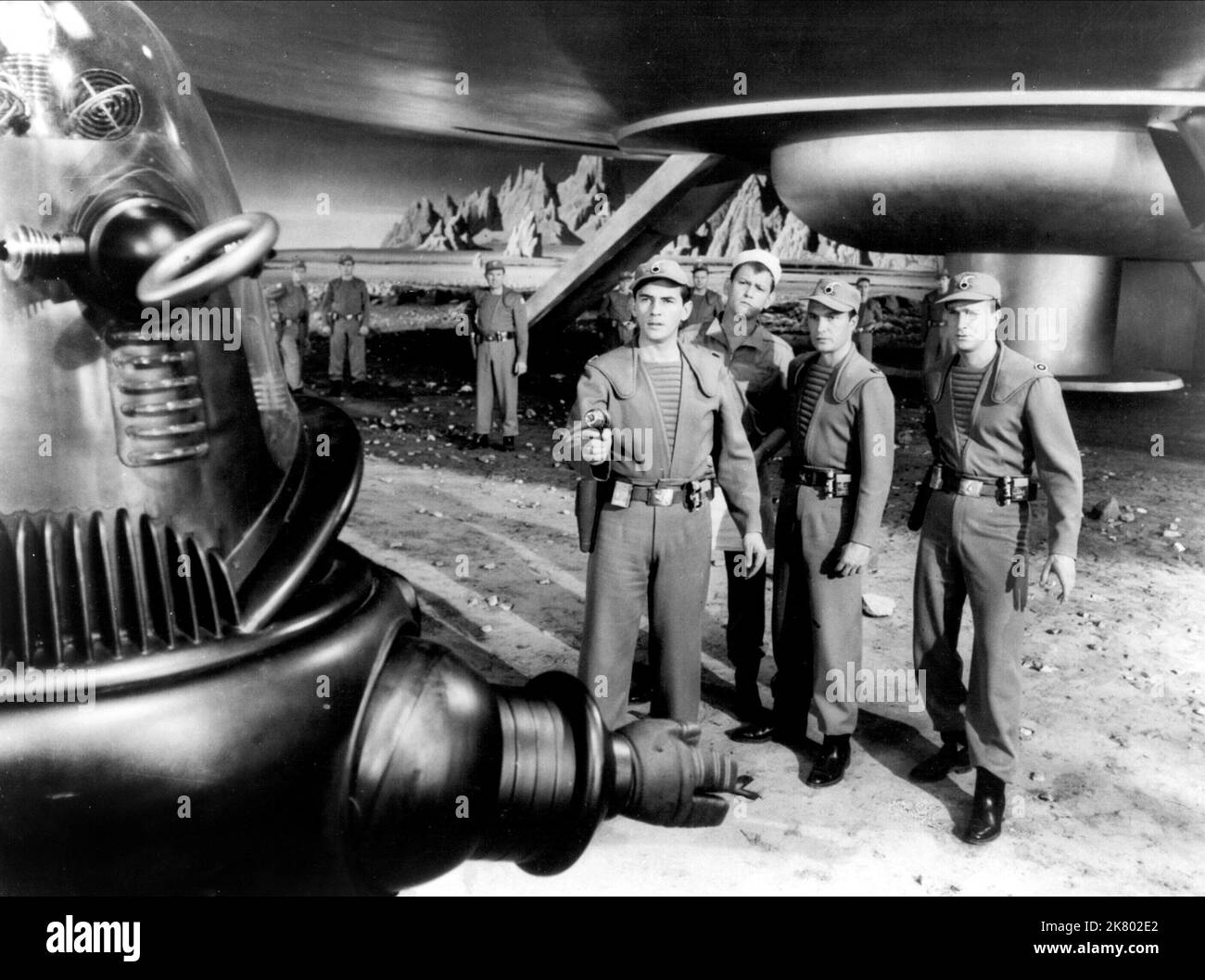 Robby The Robot, Warren Stevens, Earl Holliman, Jack Kelly & Leslie Nielsen Film: Forbidden Planet (USA 1956) Characters: Himself, Lt. 'Doc' Ostrow M.D., Cook, Lt. Jerry Farman, Commander J. J. Adams  Director: Fred M.Wilcox 23 March 1956   **WARNING** This Photograph is for editorial use only and is the copyright of MGM and/or the Photographer assigned by the Film or Production Company and can only be reproduced by publications in conjunction with the promotion of the above Film. A Mandatory Credit To MGM is required. The Photographer should also be credited when known. No commercial use can Stock Photo