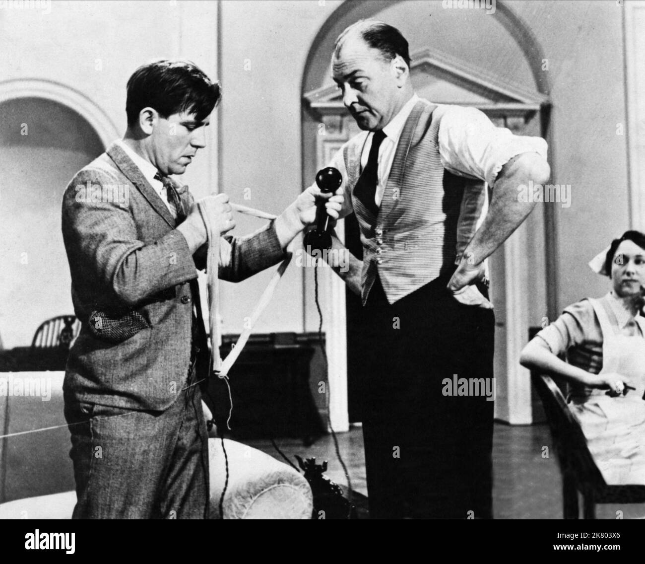 Norman Wisdom Film: Up In The World (GB 1956) Characters: Norman  Director: John Paddy Carstairs 06 December 1956   **WARNING** This Photograph is for editorial use only and is the copyright of RANK ORGANISATION and/or the Photographer assigned by the Film or Production Company and can only be reproduced by publications in conjunction with the promotion of the above Film. A Mandatory Credit To RANK ORGANISATION is required. The Photographer should also be credited when known. No commercial use can be granted without written authority from the Film Company. Stock Photo