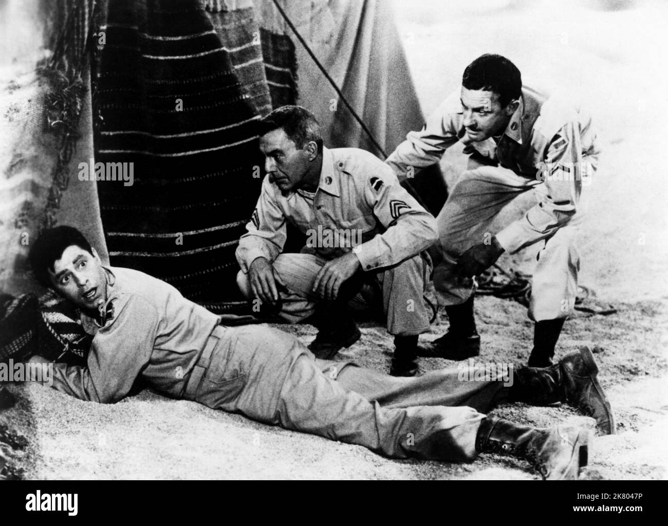 Jerry Lewis, David Wayne & Joe Mantell Film: The Sad Sack (USA 1957) Characters: Private Meredith C. Bixby,Corporal Larry Dolan & Pvt. Stan Wenaslawsky  Director: George Marshall 27 November 1957   **WARNING** This Photograph is for editorial use only and is the copyright of COLUMBIA PICTURES and/or the Photographer assigned by the Film or Production Company and can only be reproduced by publications in conjunction with the promotion of the above Film. A Mandatory Credit To COLUMBIA PICTURES is required. The Photographer should also be credited when known. No commercial use can be granted with Stock Photo