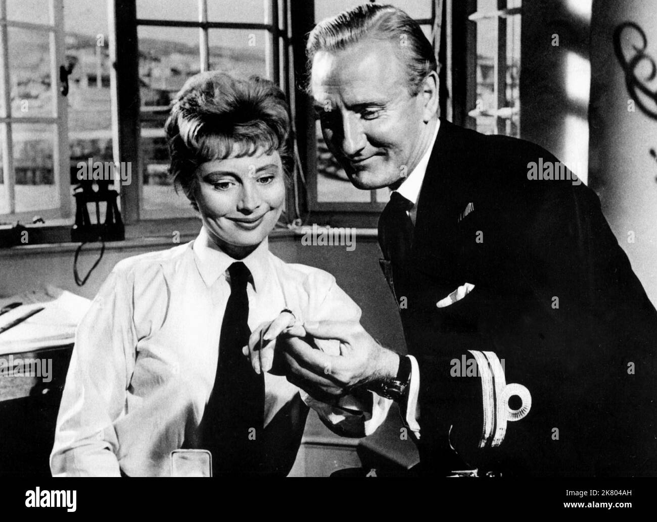 Elvi Hale & Leslie Phillips Film: The Navy Lark (1956) Characters: Leadig WREN Heather & Lt. Pouter  Director: Gordon Parry 01 November 1959   **WARNING** This Photograph is for editorial use only and is the copyright of 20TH CENTURY FOX and/or the Photographer assigned by the Film or Production Company and can only be reproduced by publications in conjunction with the promotion of the above Film. A Mandatory Credit To 20TH CENTURY FOX is required. The Photographer should also be credited when known. No commercial use can be granted without written authority from the Film Company. Stock Photo