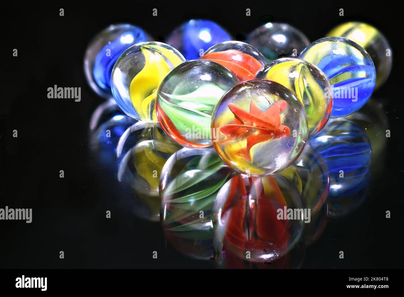 fun game for kids with colored glass marbles, glass balls Stock Photo -  Alamy