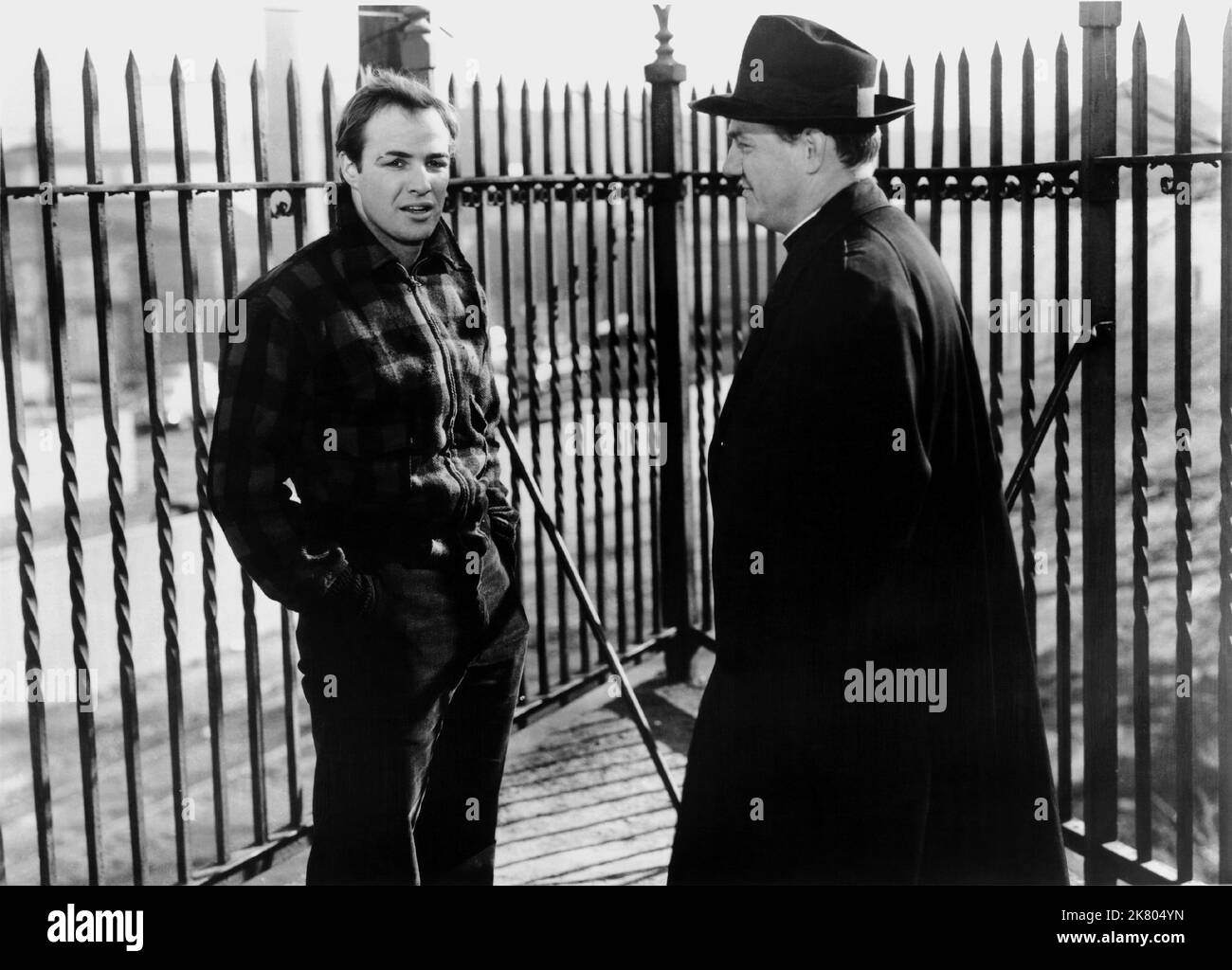 Marlon Brando & Karl Malden Film: On The Waterfront (USA 1964) Characters: Terry Malloy & Father Barry  Director: Elia Kazan 22 June 1954   **WARNING** This Photograph is for editorial use only and is the copyright of COLUMBIA PICTURES and/or the Photographer assigned by the Film or Production Company and can only be reproduced by publications in conjunction with the promotion of the above Film. A Mandatory Credit To COLUMBIA PICTURES is required. The Photographer should also be credited when known. No commercial use can be granted without written authority from the Film Company. Stock Photo