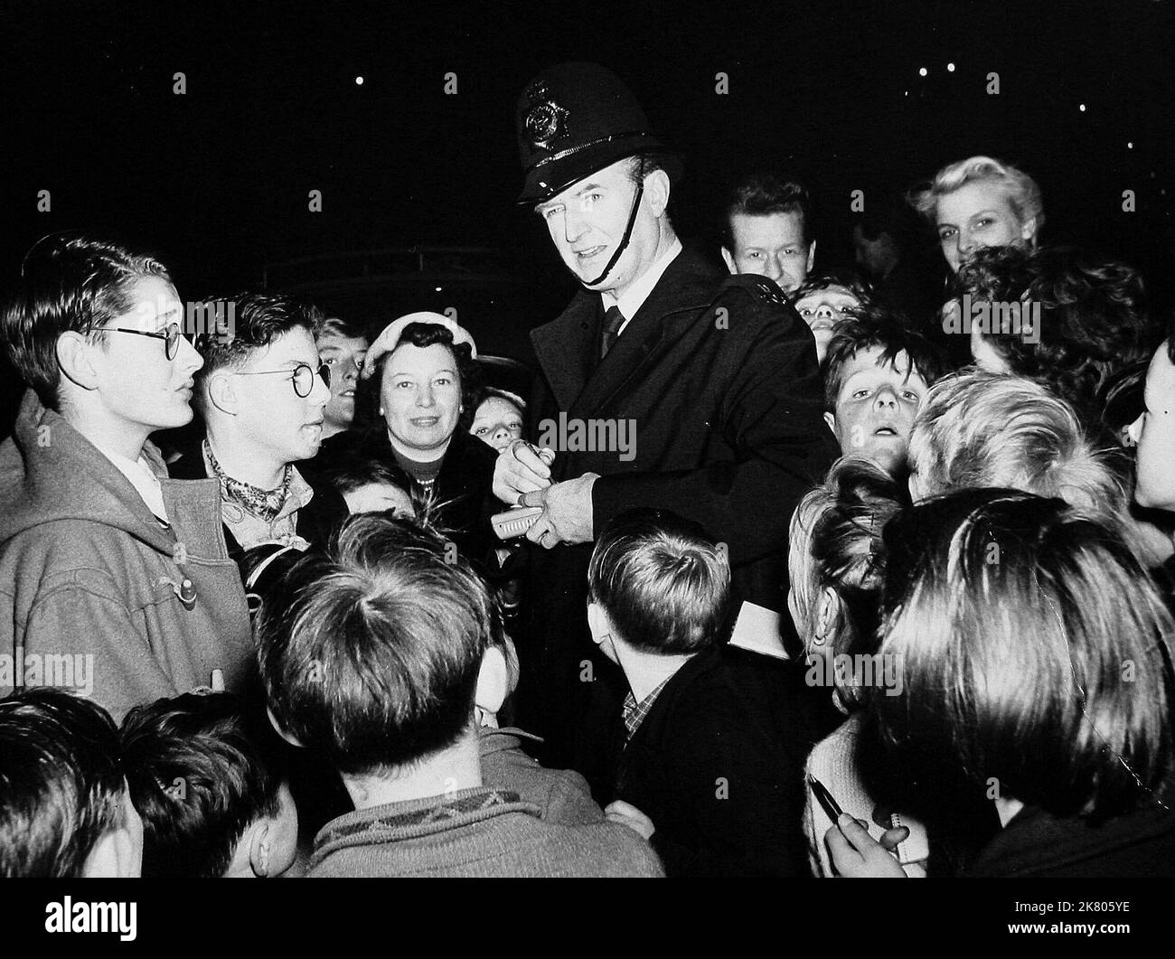 Jack Warner With Fans Television: Dixon Of Dock Green (1959) Characters: PC George Dixon WITH  12 January 1957   **WARNING** This Photograph is for editorial use only and is the copyright of BBC and/or the Photographer assigned by the Film or Production Company and can only be reproduced by publications in conjunction with the promotion of the above Film. A Mandatory Credit To BBC is required. The Photographer should also be credited when known. No commercial use can be granted without written authority from the Film Company. Stock Photo