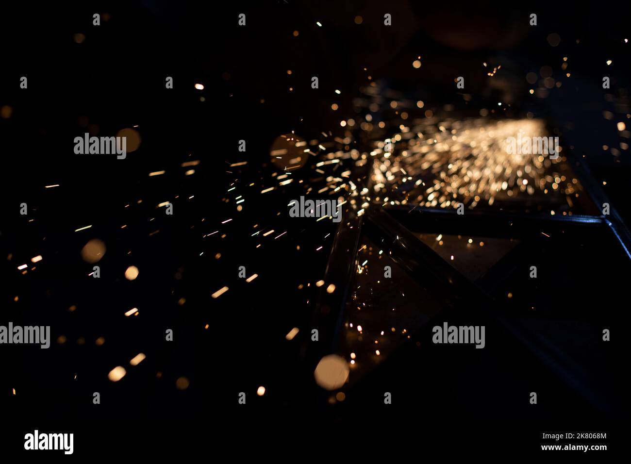 Metal grinding. Sparks from friction. Lights in dark. Chaotic flight of