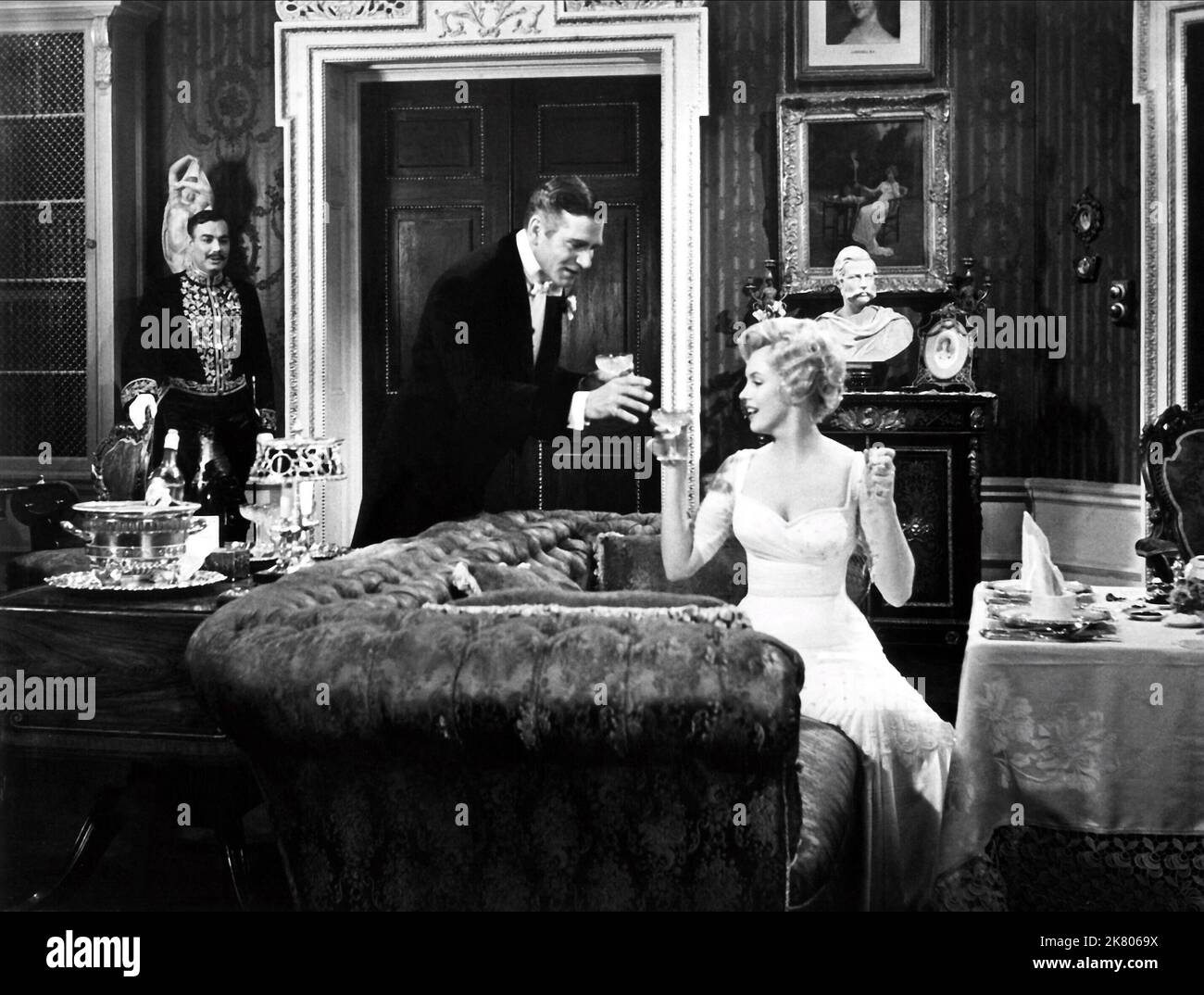 Paul Hardwick, Laurence Olivier & Marilyn Monroe Film: The Prince And The Showgirl (USA/UK 1957) Characters: Major Domo, Charles, the Prince Regent, Elsie Marina  Director: Laurence Olivier 13 June 1957   **WARNING** This Photograph is for editorial use only and is the copyright of WARNER BROS. and/or the Photographer assigned by the Film or Production Company and can only be reproduced by publications in conjunction with the promotion of the above Film. A Mandatory Credit To WARNER BROS. is required. The Photographer should also be credited when known. No commercial use can be granted without Stock Photo
