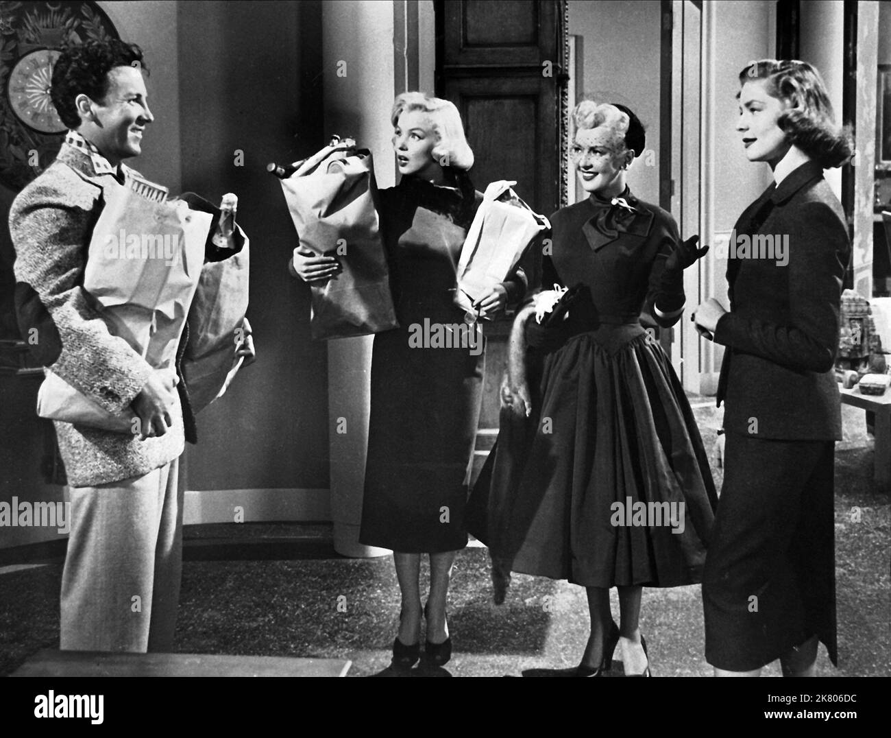 Rory Calhoun, Marilyn Monroe, Betty Grable & Lauren Bacall Film: How To Marry A Millionaire (USA 1953) Characters: Eben, Pola Debevoise, Loco Dempsey, Schatze Page  Director: Jean Negulesco 04 November 1953   **WARNING** This Photograph is for editorial use only and is the copyright of 20TH CENTURY FOX and/or the Photographer assigned by the Film or Production Company and can only be reproduced by publications in conjunction with the promotion of the above Film. A Mandatory Credit To 20TH CENTURY FOX is required. The Photographer should also be credited when known. No commercial use can be gra Stock Photo