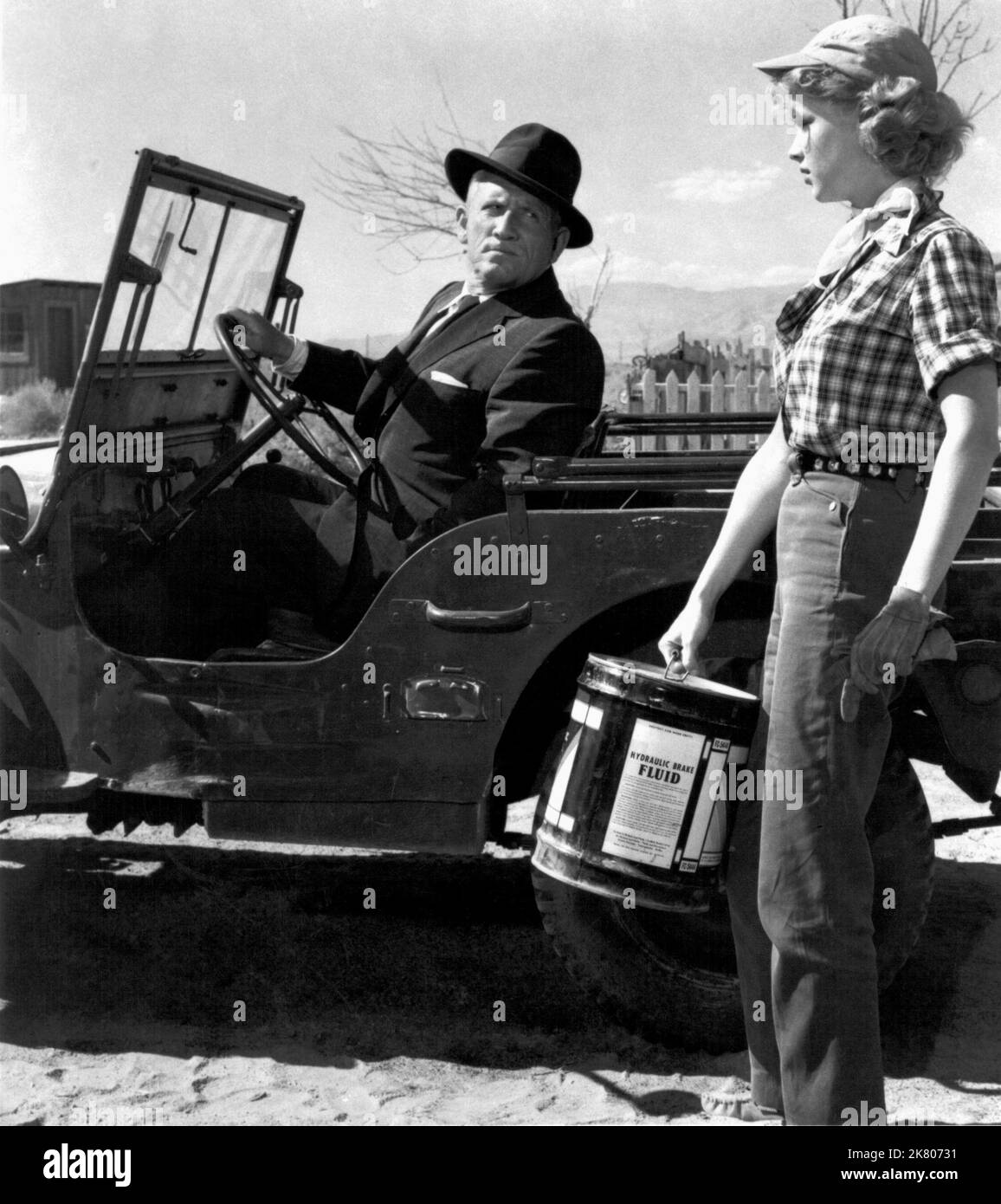 Spencer Tracy & Anne Francis Film: Bad Day At Black Rock (USA 1955) Characters: John J. Macreedy, Liz Wirth  / Jeep: Willys Mb (Von Willys-Overland) Director: John Sturges 07 January 1955   **WARNING** This Photograph is for editorial use only and is the copyright of MGM and/or the Photographer assigned by the Film or Production Company and can only be reproduced by publications in conjunction with the promotion of the above Film. A Mandatory Credit To MGM is required. The Photographer should also be credited when known. No commercial use can be granted without written authority from the Film Stock Photo