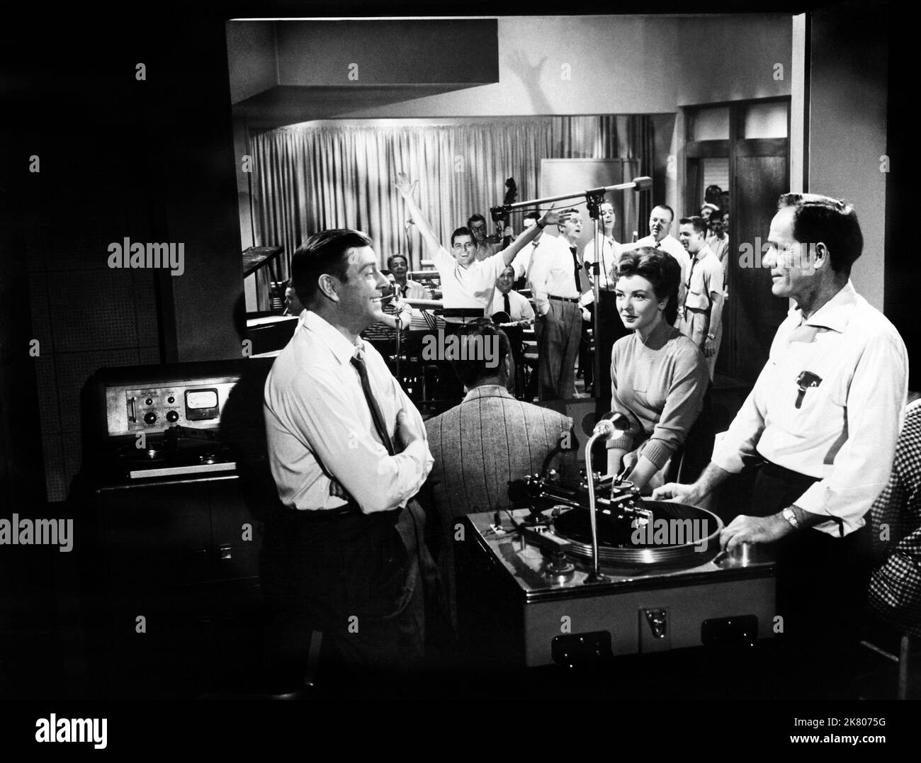 Paul Langton, Johnny Desmond & Meg Myles Film: Calypso Heat Wave (1957) Characters: Mack Adams, Johnny Conroy, Mona DeLuce  Director: Fred F. Sanders 28 June 1957   **WARNING** This Photograph is for editorial use only and is the copyright of COLUMBIA PICTURES and/or the Photographer assigned by the Film or Production Company and can only be reproduced by publications in conjunction with the promotion of the above Film. A Mandatory Credit To COLUMBIA PICTURES is required. The Photographer should also be credited when known. No commercial use can be granted without written authority from the Fi Stock Photo