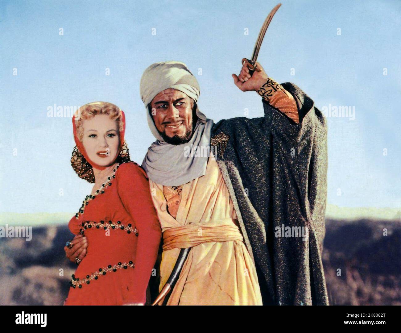 Virginia Mayo & Rex Harrison Film: King Richard And The Crusaders (1954) Characters: Lady Edith Plantagenet & Emir Hderim Sultan Saladin  Director: David Butler 07 August 1954   **WARNING** This Photograph is for editorial use only and is the copyright of WARNER BROS and/or the Photographer assigned by the Film or Production Company and can only be reproduced by publications in conjunction with the promotion of the above Film. A Mandatory Credit To WARNER BROS is required. The Photographer should also be credited when known. No commercial use can be granted without written authority from the F Stock Photo