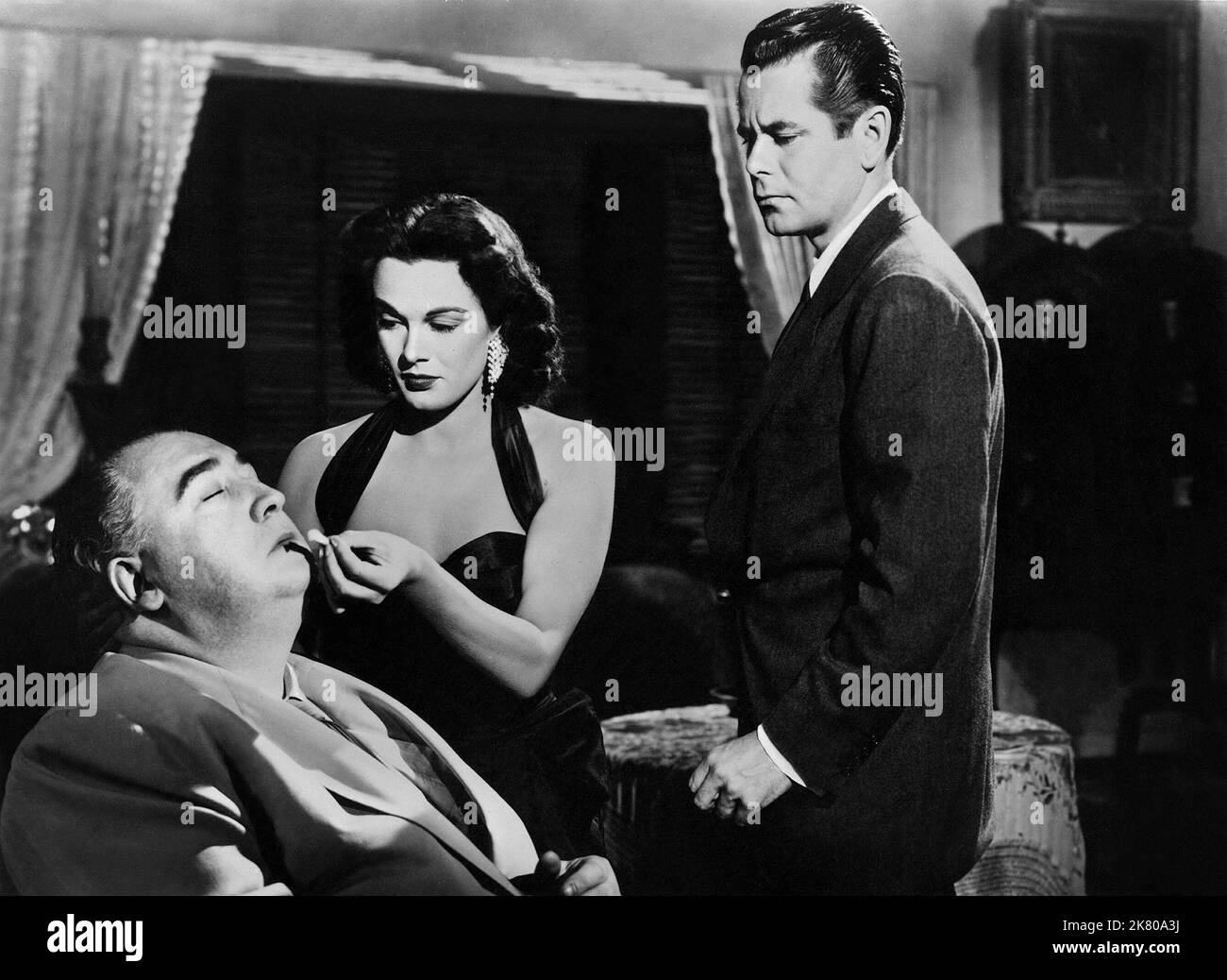 Frank L. Sullivan, Patricia Medina & Glenn Ford Film: Plunder Of The Sun (1954) Characters: ,Anna Luz & Al Colby  Director: John Farrow 26 August 1953   **WARNING** This Photograph is for editorial use only and is the copyright of WARNER BROS and/or the Photographer assigned by the Film or Production Company and can only be reproduced by publications in conjunction with the promotion of the above Film. A Mandatory Credit To WARNER BROS is required. The Photographer should also be credited when known. No commercial use can be granted without written authority from the Film Company. Stock Photo