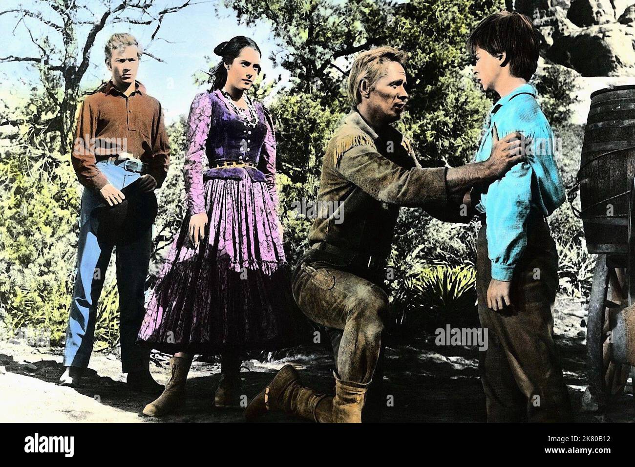 Ray Stricklyn, Susan Kohner, Richard Widmark & Tommy Rettig Film: The Last Wagon (1956) Characters: Clint,Jolie Normand,Comanche Todd & Billy  Director: Delmer Daves 21 September 1956   **WARNING** This Photograph is for editorial use only and is the copyright of 20TH and/or the Photographer assigned by the Film or Production Company and can only be reproduced by publications in conjunction with the promotion of the above Film. A Mandatory Credit To 20TH is required. The Photographer should also be credited when known. No commercial use can be granted without written authority from the Film Co Stock Photo