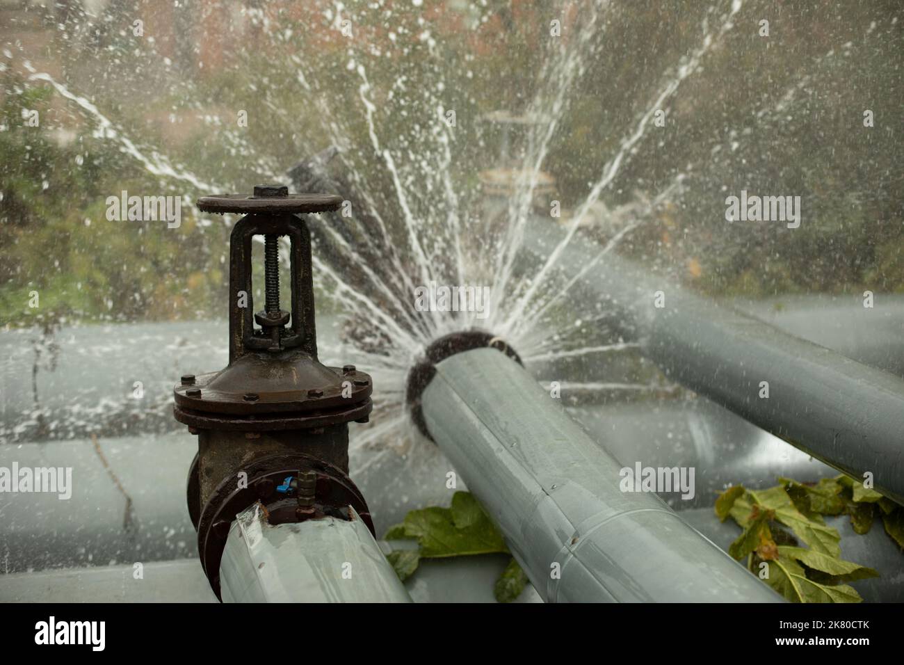 Pipeline accident. Boiling water pours from pipe. Boiler room emergency