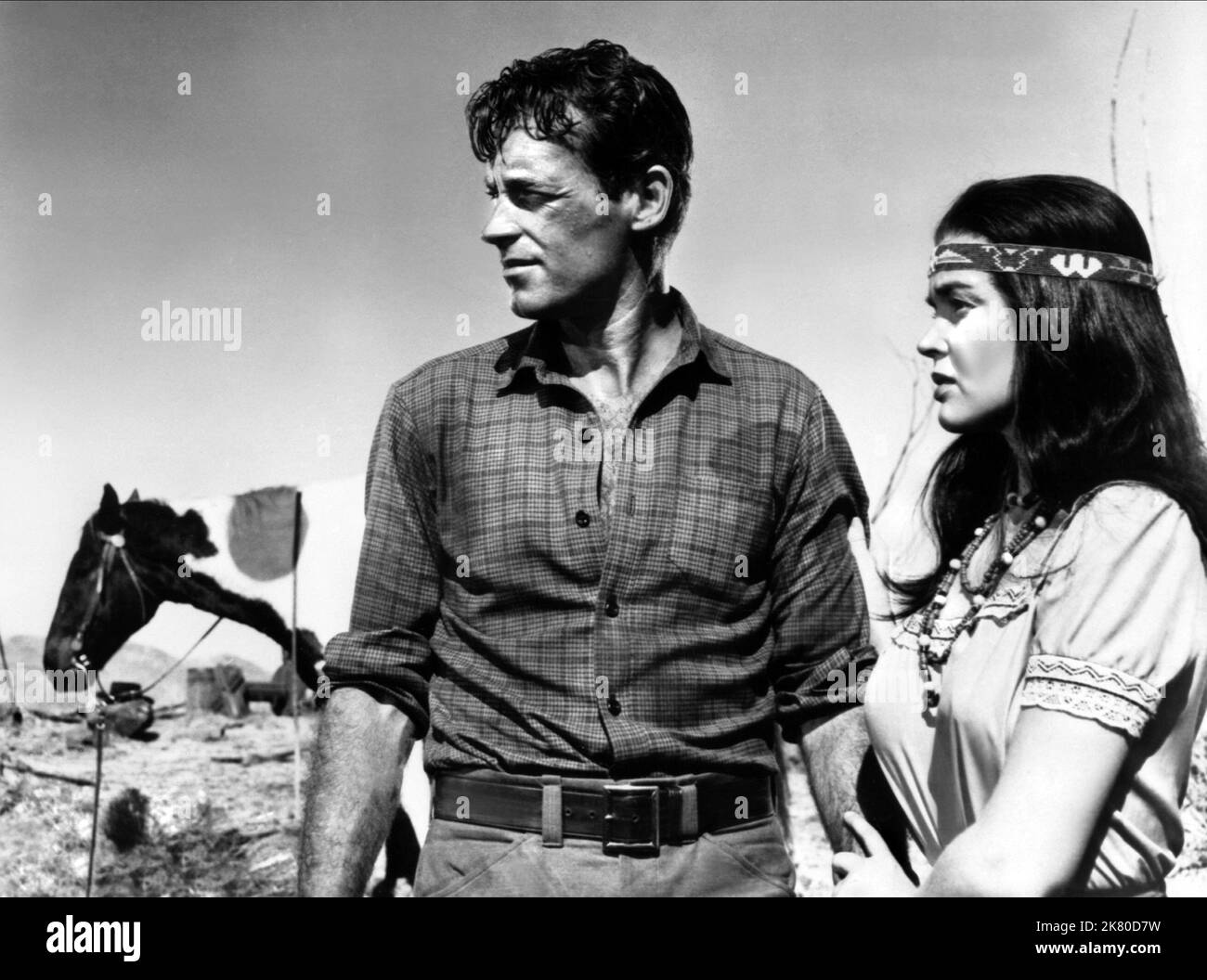 Guy Madison & Kathryn Grant Film: Reprisal! (1956) Characters: Frank Madden aka Neola, Taini  Director: George Sherman 01 November 1956   **WARNING** This Photograph is for editorial use only and is the copyright of The Film Company and/or the Photographer assigned by the Film or Production Company and can only be reproduced by publications in conjunction with the promotion of the above Film. A Mandatory Credit To The Film Company is required. The Photographer should also be credited when known. No commercial use can be granted without written authority from the Film Company. Stock Photo