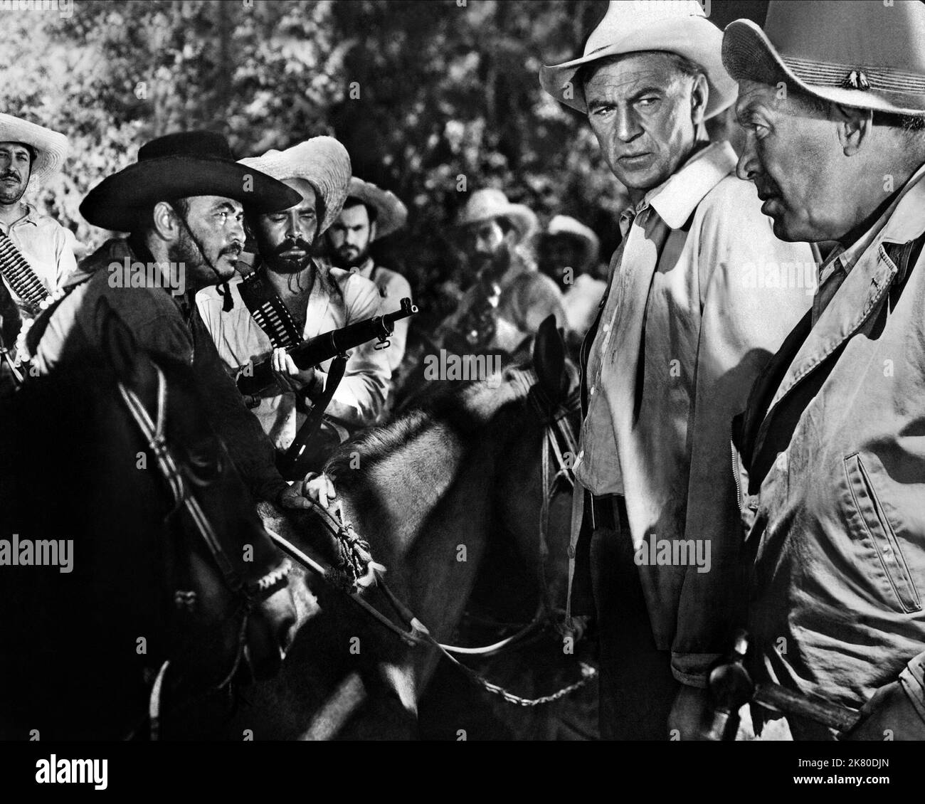 Ian Macdonald, Juan Garcia, Richard Karlan, Gary Cooper & Ward Bond Film: Blowing Wild (1953) Characters: Jackson, El Gavilan, Henderson, Jeff Dawson, Dutch Peterson  Director: Hugo Fregonese 07 October 1953   **WARNING** This Photograph is for editorial use only and is the copyright of WARNER BROS and/or the Photographer assigned by the Film or Production Company and can only be reproduced by publications in conjunction with the promotion of the above Film. A Mandatory Credit To WARNER BROS is required. The Photographer should also be credited when known. No commercial use can be granted with Stock Photo