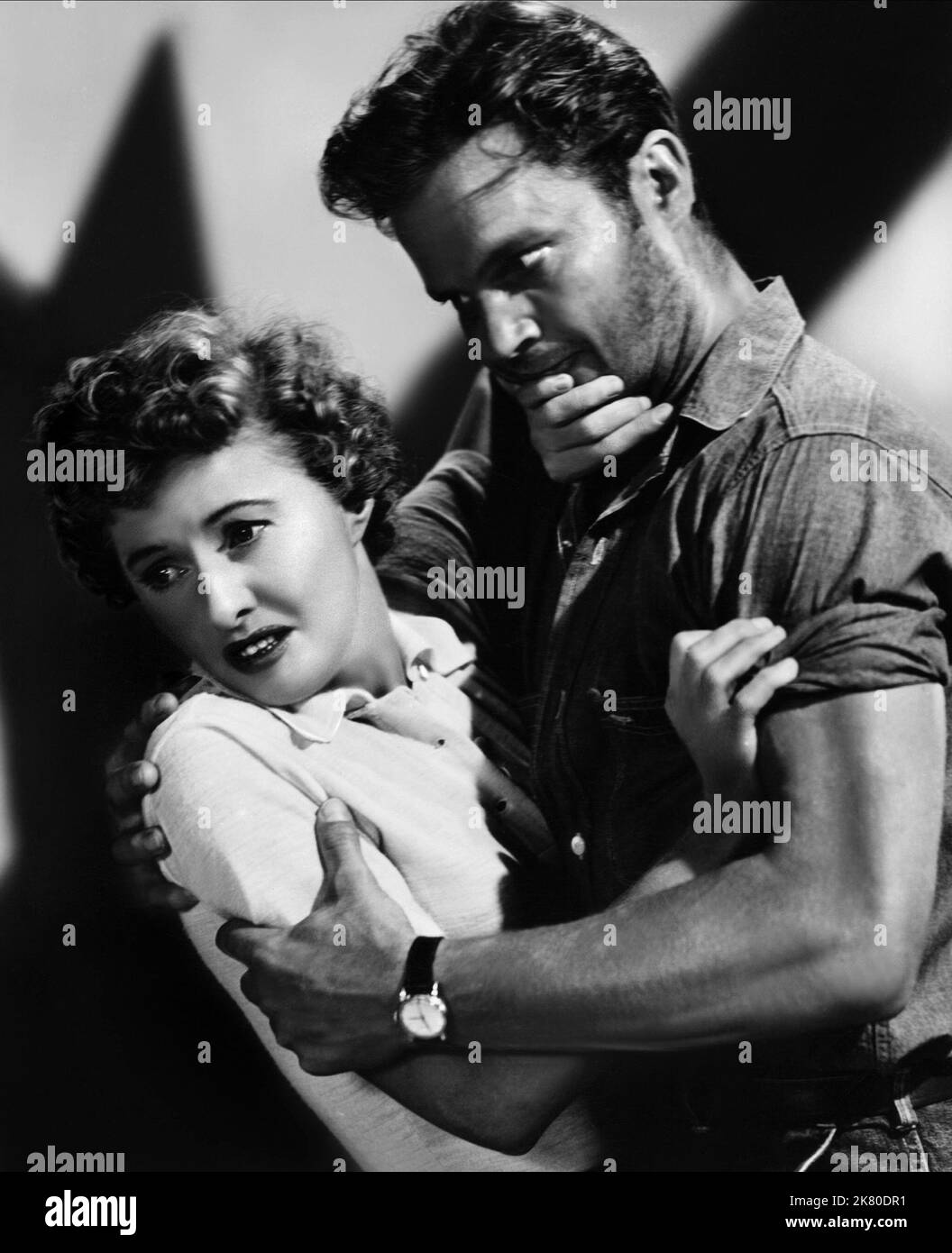 Barbara Stanwyck & Ralph Meeker  Film Jeopardy (1953) Characters: Helen Stilwin, Lawson  Director: John Sturges 30 March 1953   **WARNING** This Photograph is for editorial use only and is the copyright of LOEW'S and/or the Photographer assigned by the  Film or Production Company and can only be reproduced by publications in conjunction with the promotion of the above  Film. A Mandatory Credit To LOEW'S is required. The Photographer should also be credited when known. No commercial use can be granted without written authority from the  Film Company. Stock Photo