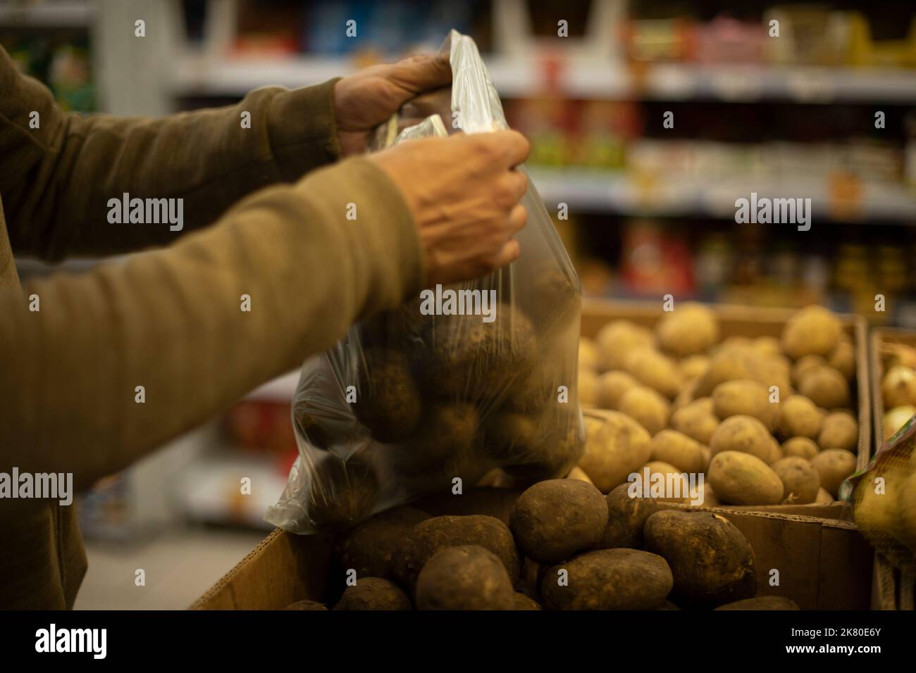 Bag with potatoes. Vegetables in kitchen. Potatoes in plastic bag