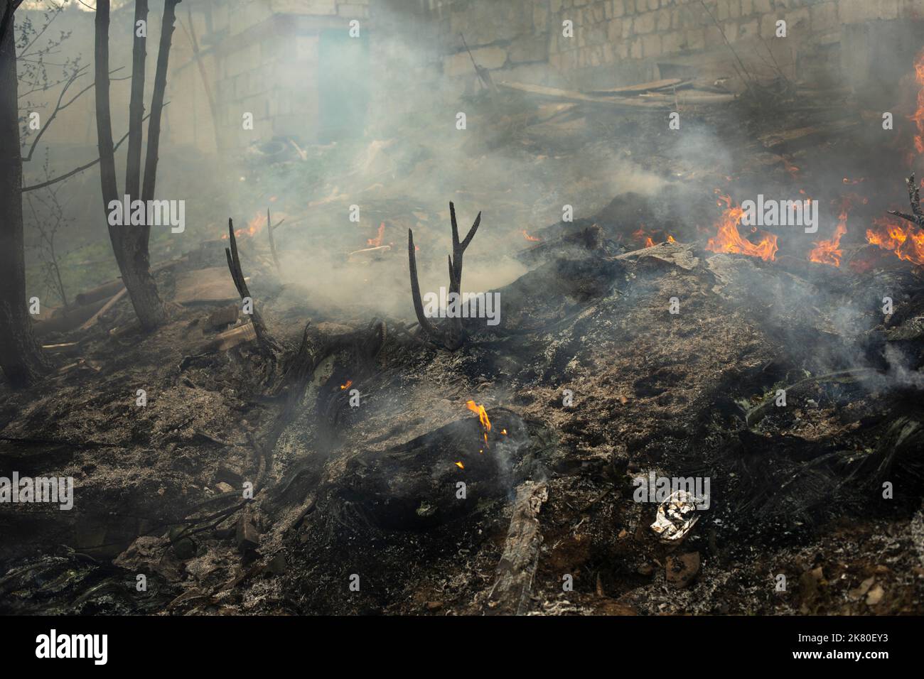 Burning of garbage. Set fire to illegal landfill. Flames and smoke