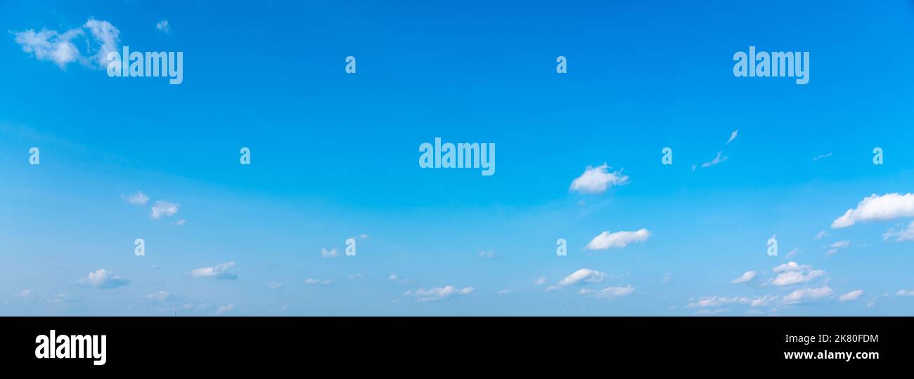Blue panoramic sky background with small white clouds Stock Photo