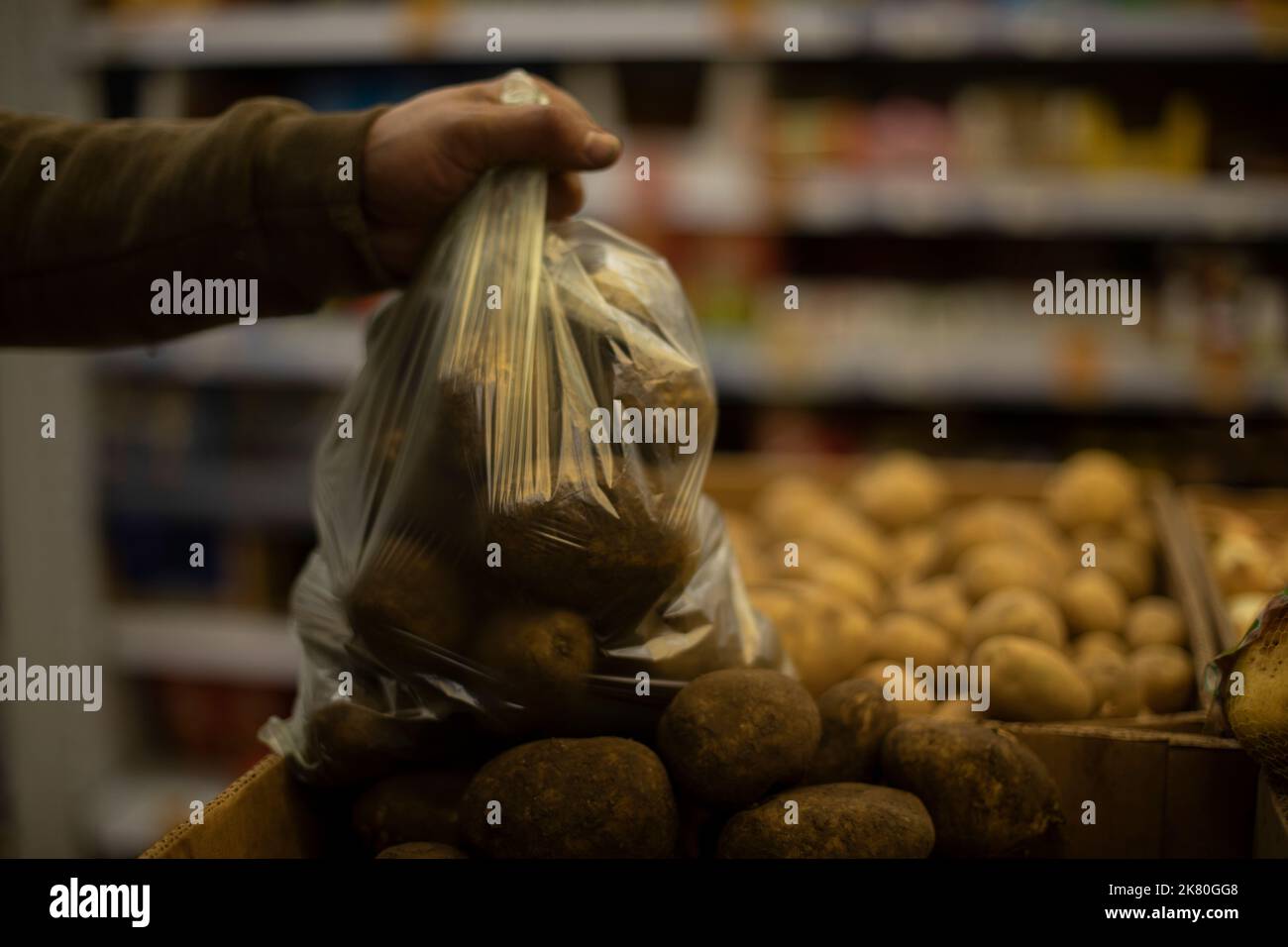 Bag with potatoes. Vegetables in kitchen. Potatoes in plastic bag