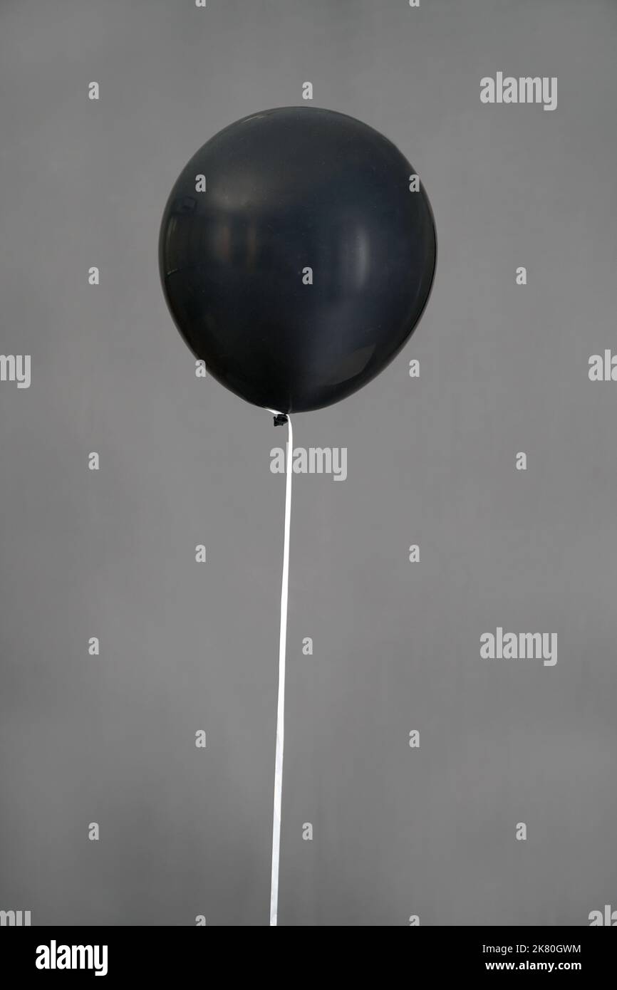 black color balloon isolated in grey background Stock Photo - Alamy