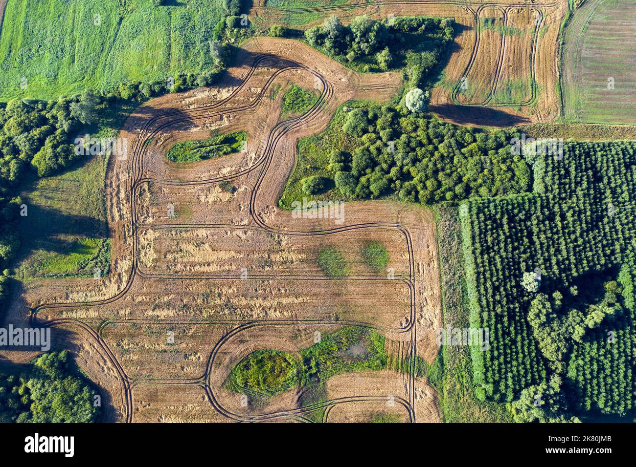 Crop fields, sinkholes and groves in nature park, Lithuania, aerial view Stock Photo