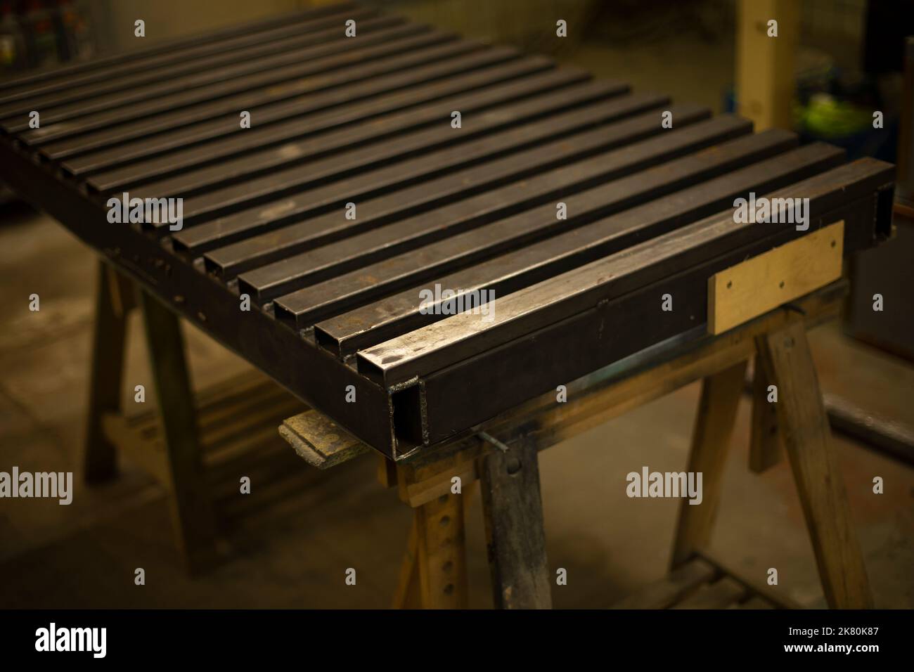 Steel table. Industrial processing. Details of work with structure. Part processing. Steel cover. Stock Photo
