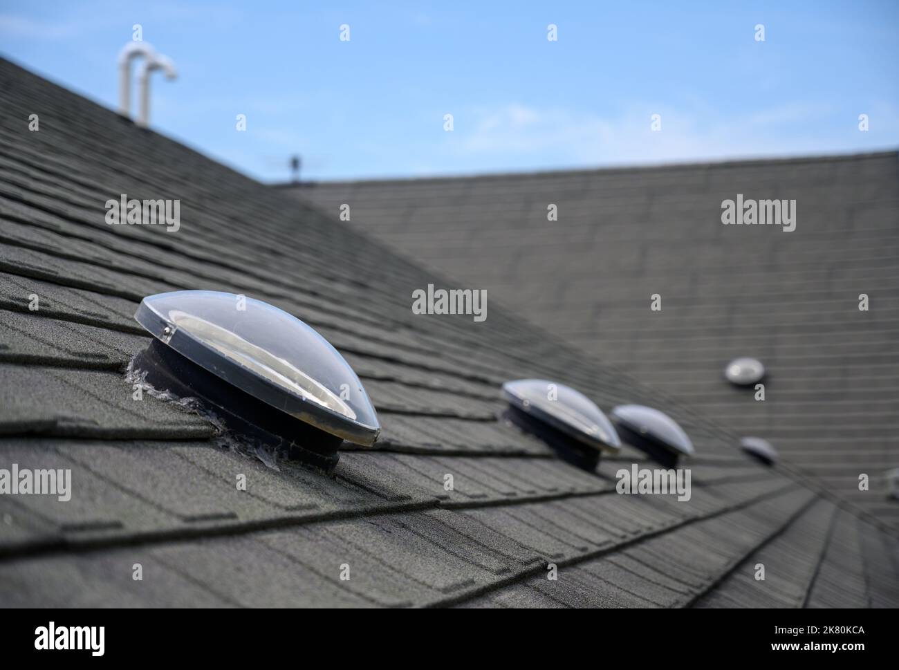 Dome shaped solar tube skylight on asphalt shingle roof Stock Photo Alamy