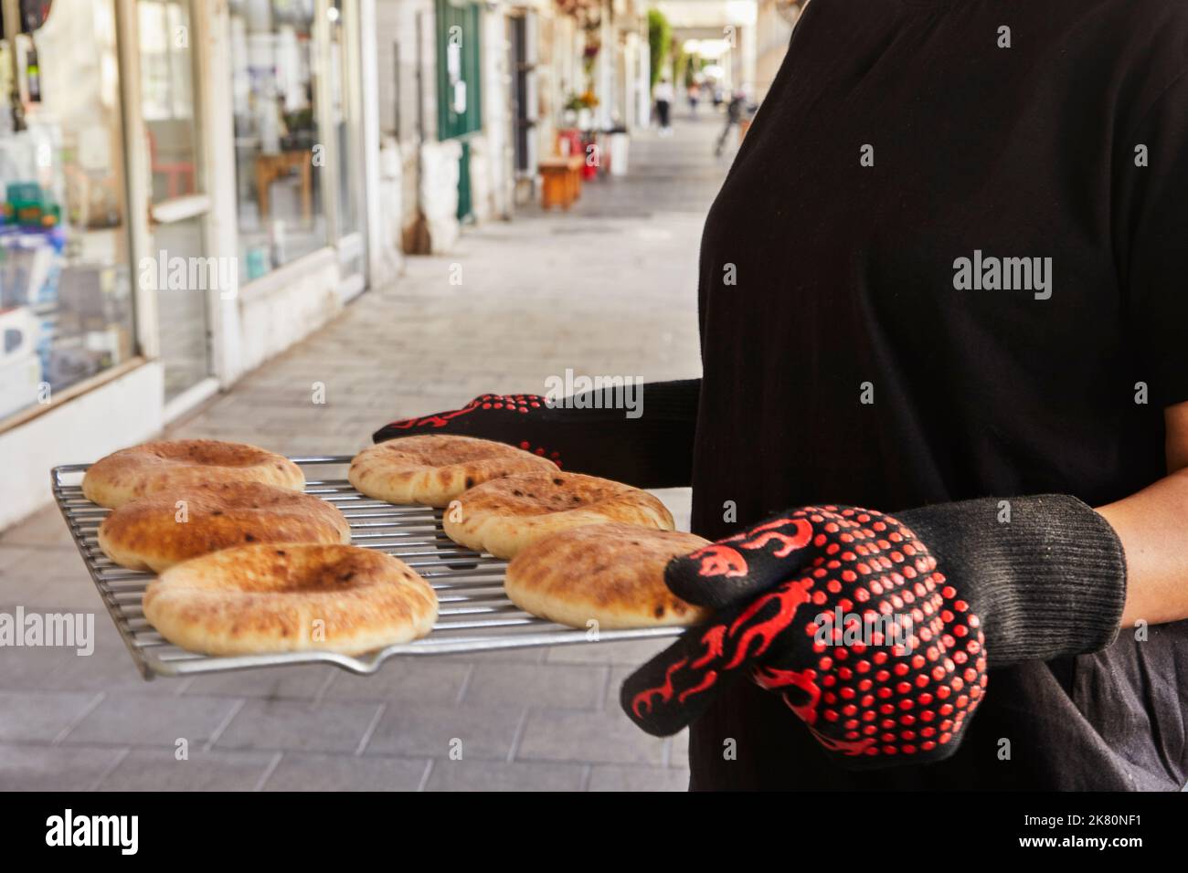 https://c8.alamy.com/comp/2K80NF1/chef-keeps-the-pita-on-the-wire-rack-after-being-baked-in-the-electric-oven-2K80NF1.jpg