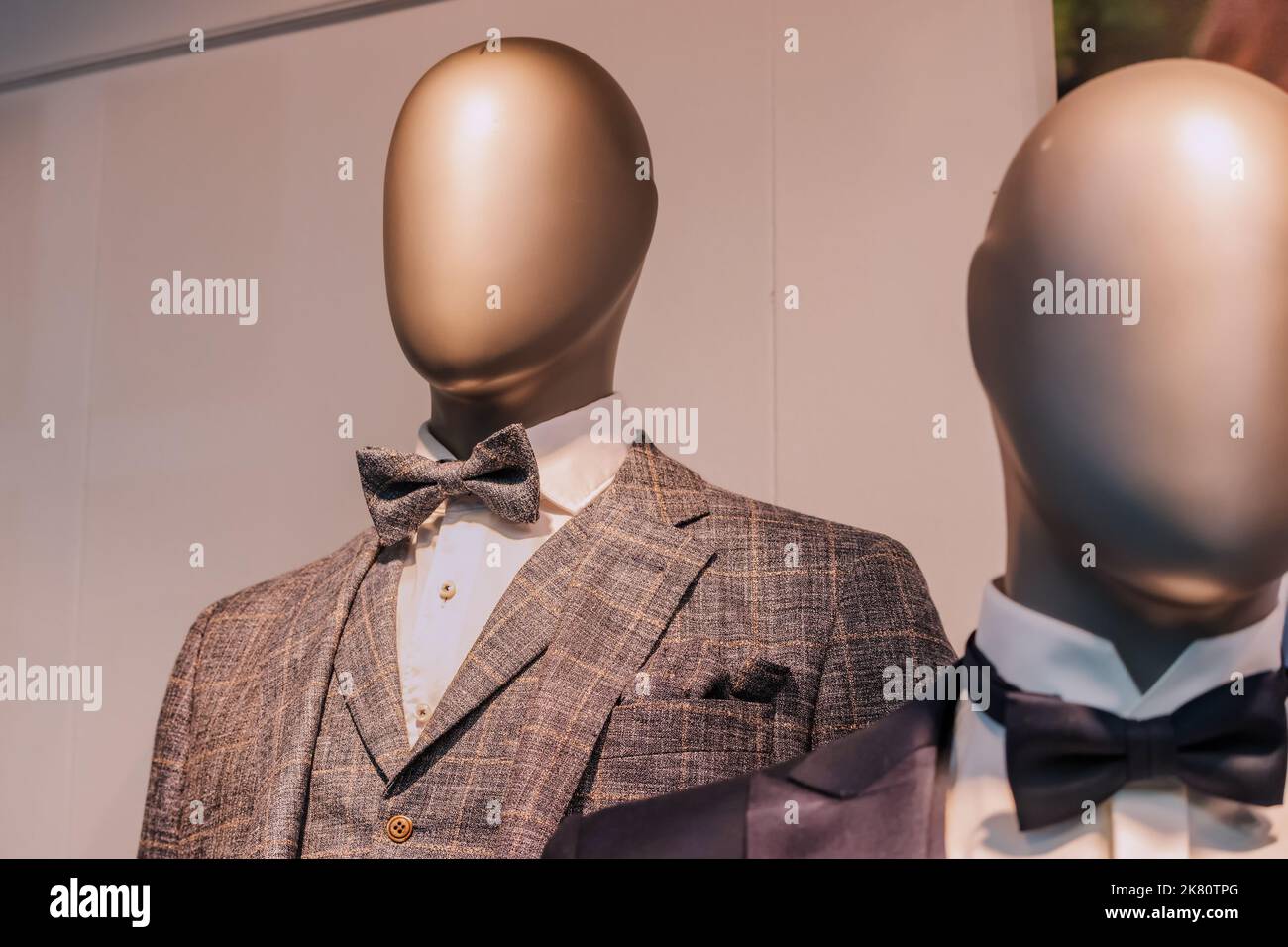 vintage retro and stylish men suits on a mannequin in a clothing store or tailor 2K80TPG