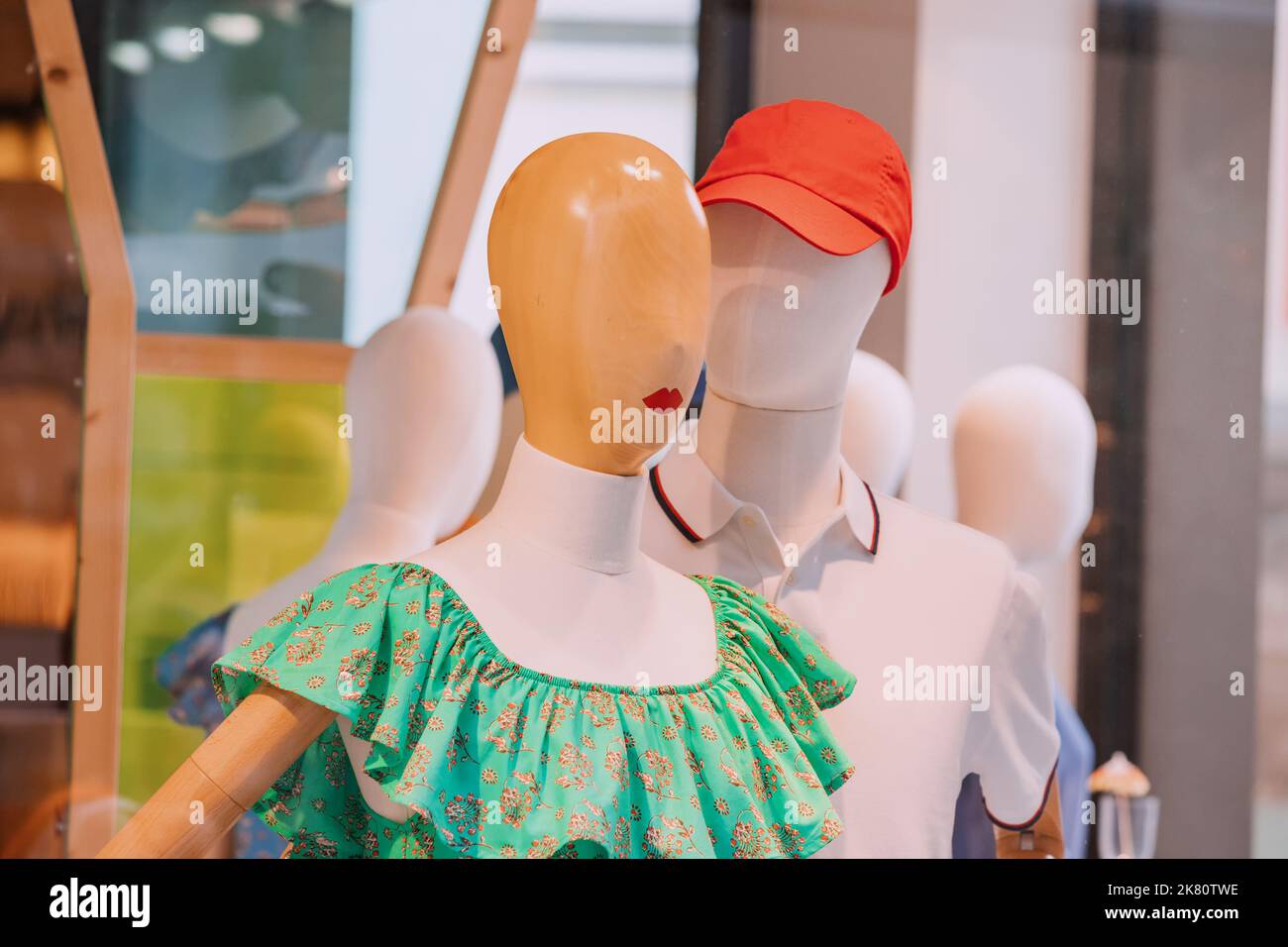 Couple of mannequins in fashionable clothes are tender hugging