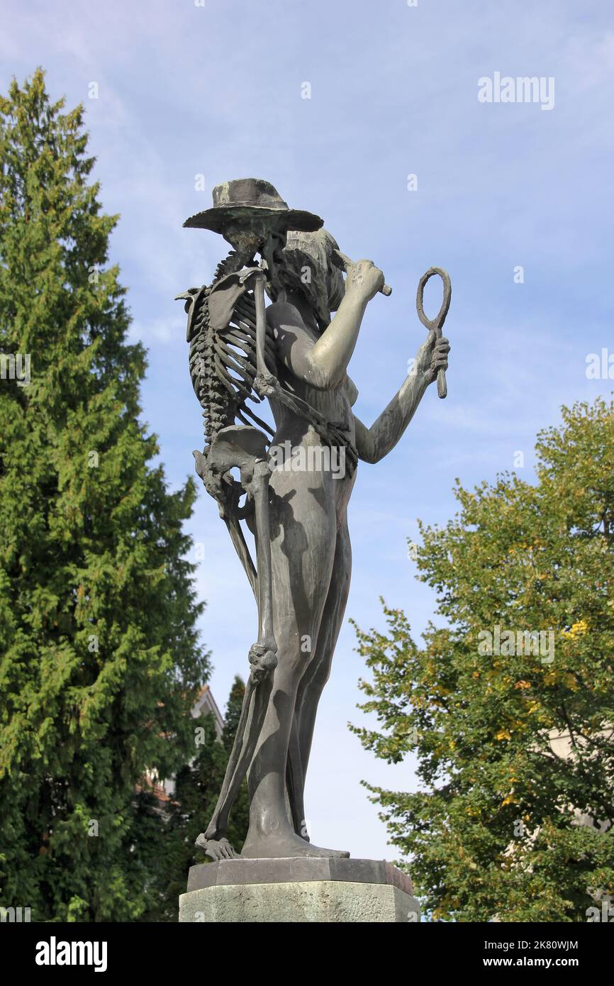 Bronze sculpture in the Swiss town Stans - 'Death and the Maiden' by the Swiss artist Rolf Brem. 'Death and the Maiden' is after the music by Robert S Stock Photo