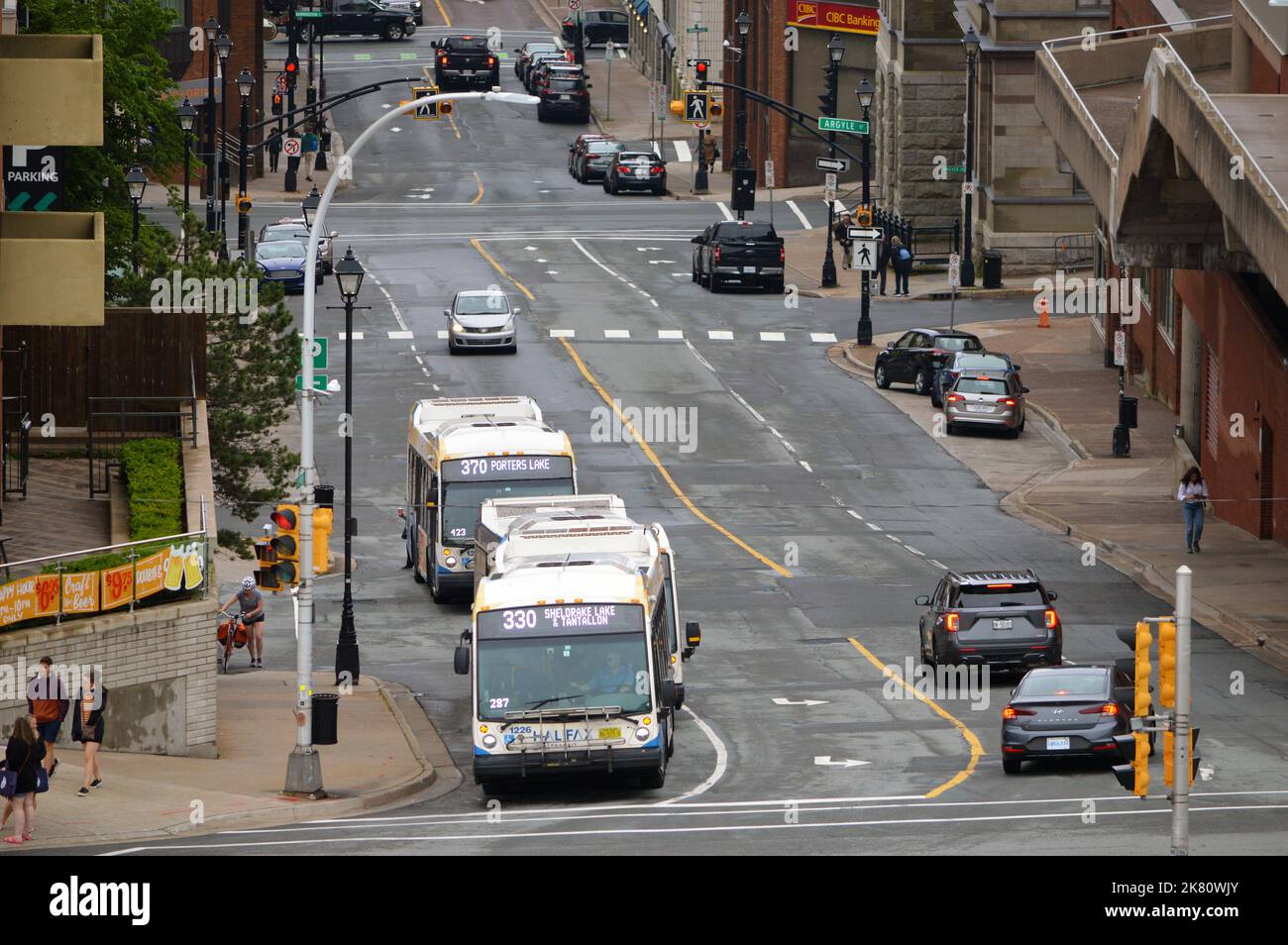 Cars and Halifax Transit buses on Duke Street, a steep street in