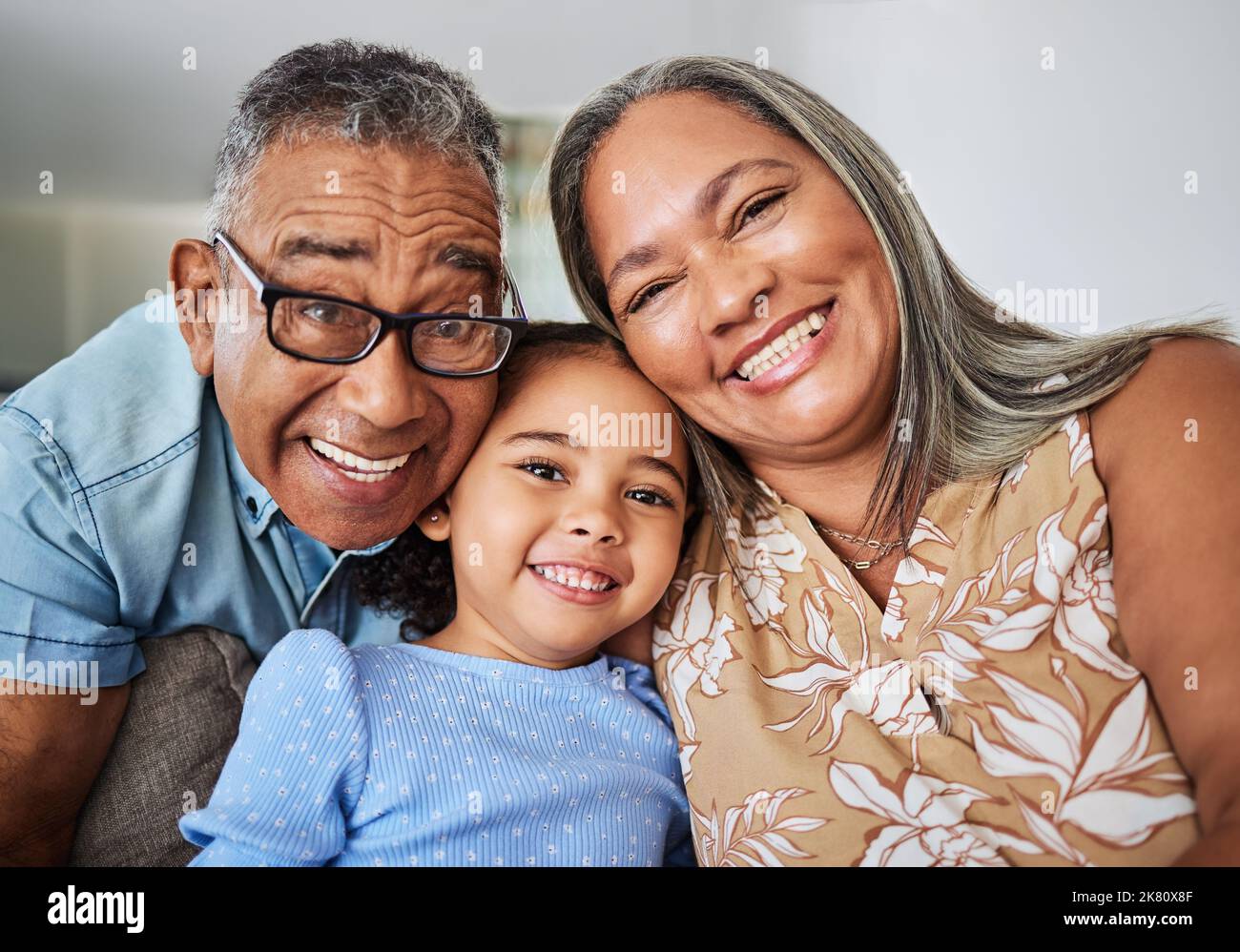 Family, grandparents and child portrait in a house relaxing, bonding