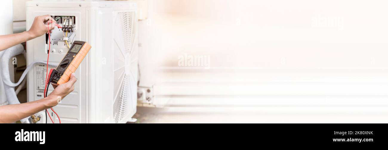 Air conditioner repairman using electricity meter to check air