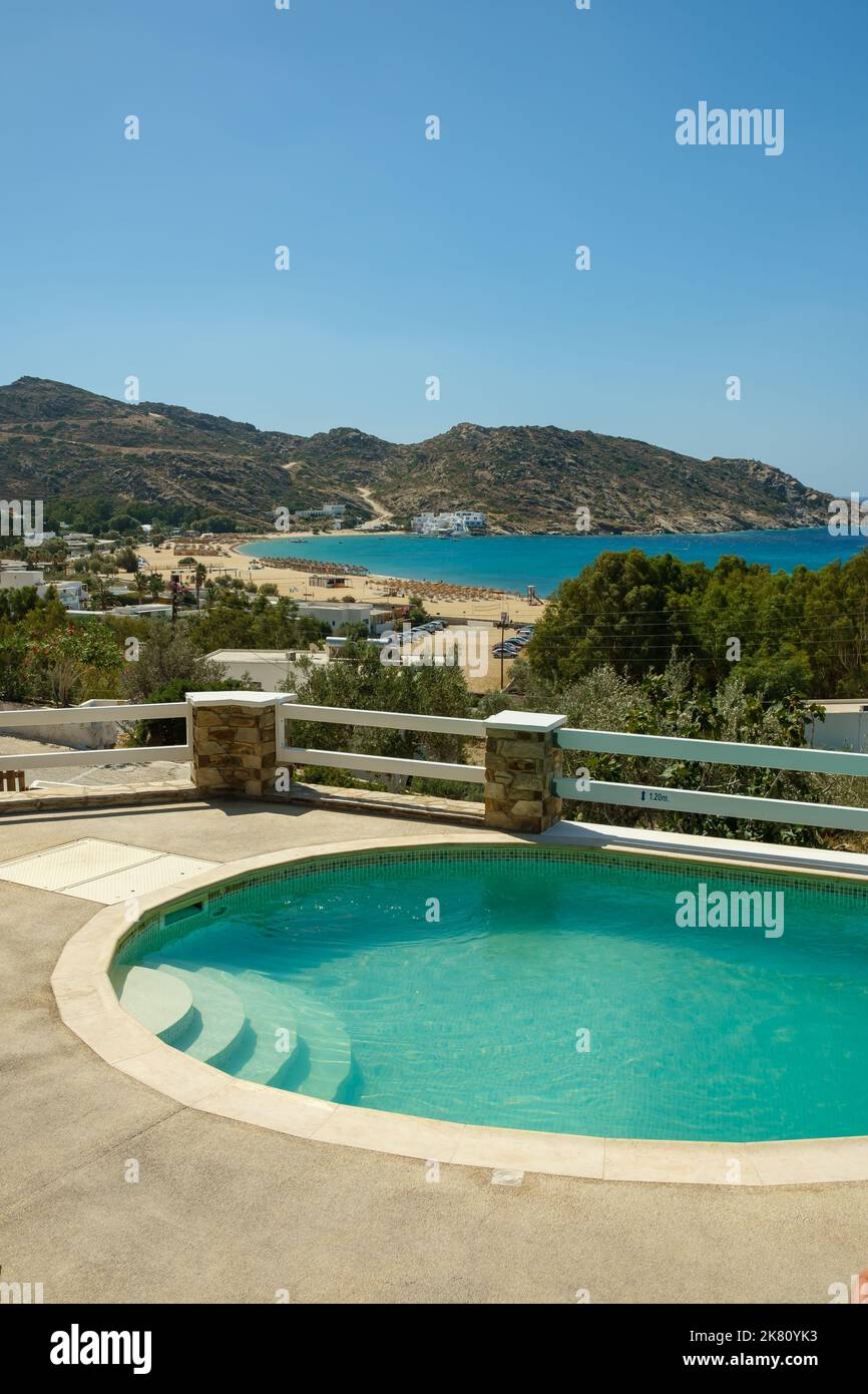 Ios, Greece - September 6, 2022 : View of a beautiful swimming pool overlooking the famous Mylopotas beach in Ios Greece Stock Photo