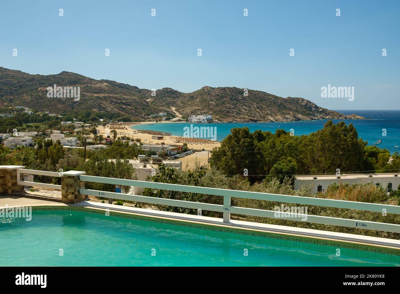 Ios, Greece - September 6, 2022 : View of a beautiful swimming pool overlooking the famous Mylopotas beach in Ios Greece Stock Photo