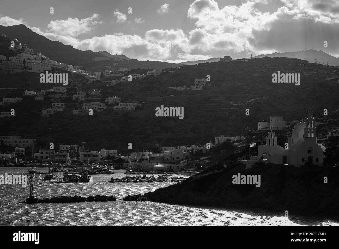 Panoramic view of the church Agia Irini, the port and the village of Ios Greece at sunrise in black and white Stock Photo