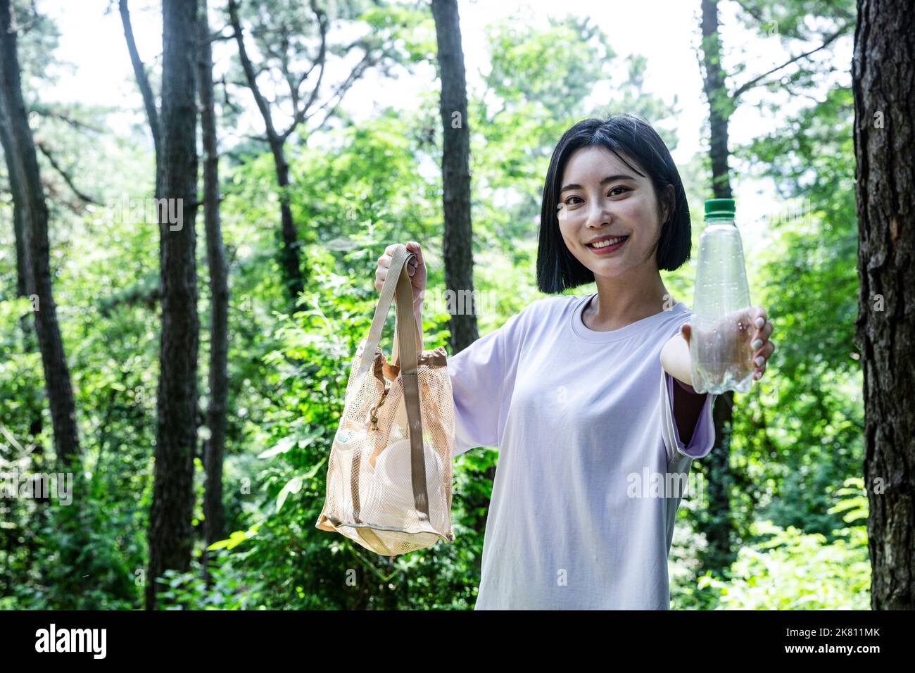 korean young woman hiking and plogging picking up litter, garbage Stock Photo Alamy