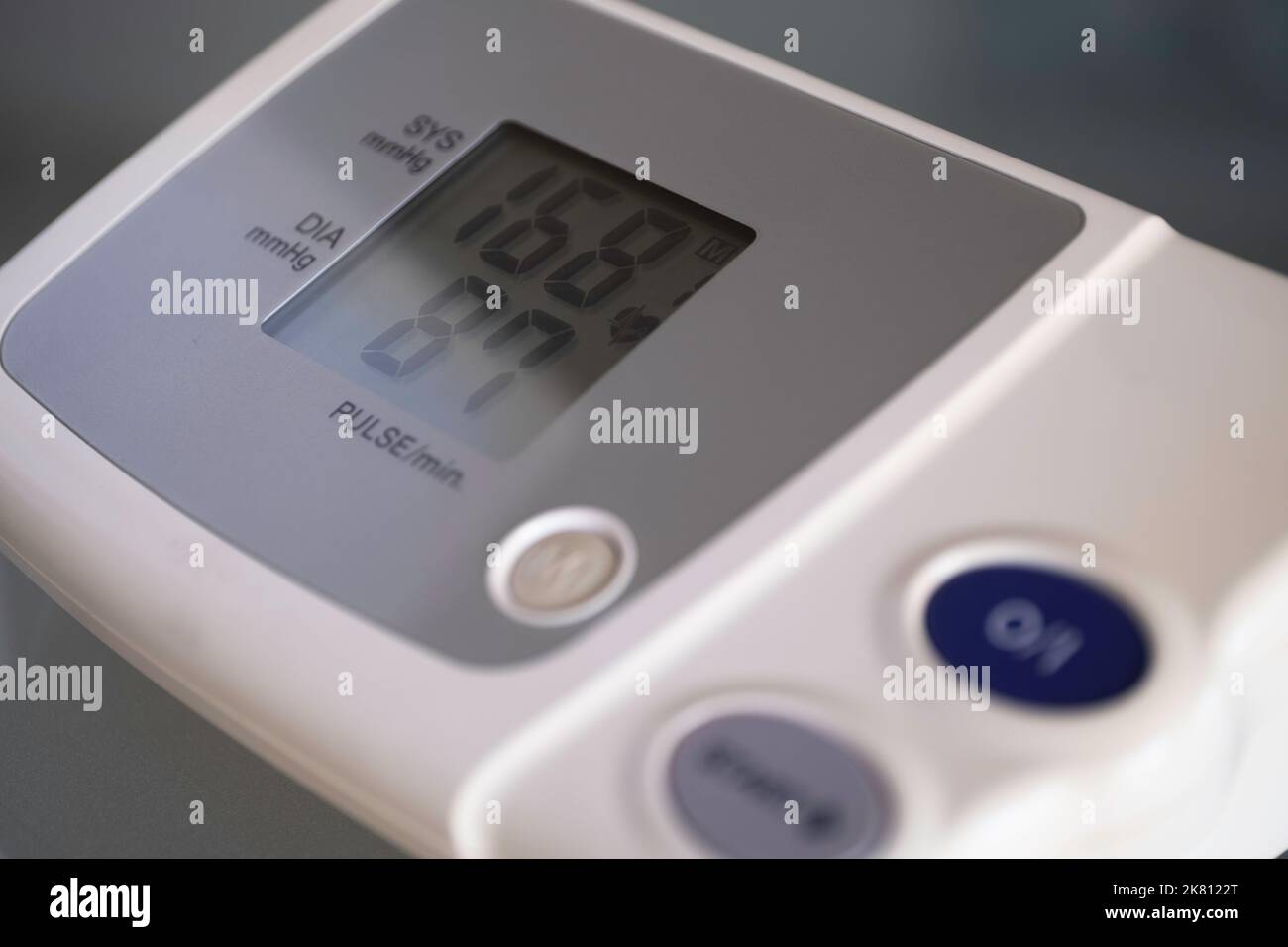 Screen of an electronic digital blood pressure monitor shows the upper