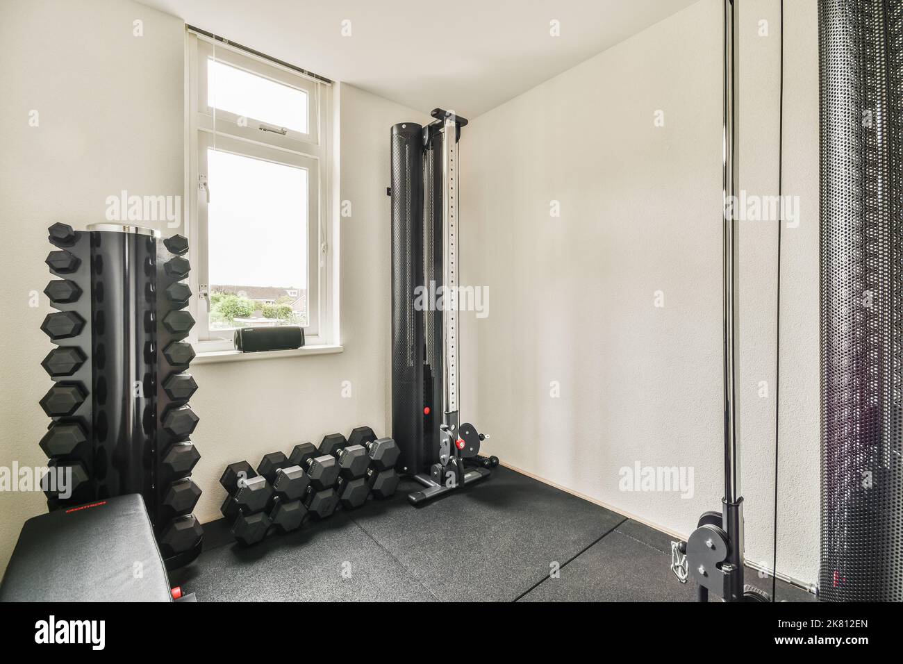Home Gym Design on wooden floor near window in spacious light room at home Stock Photo